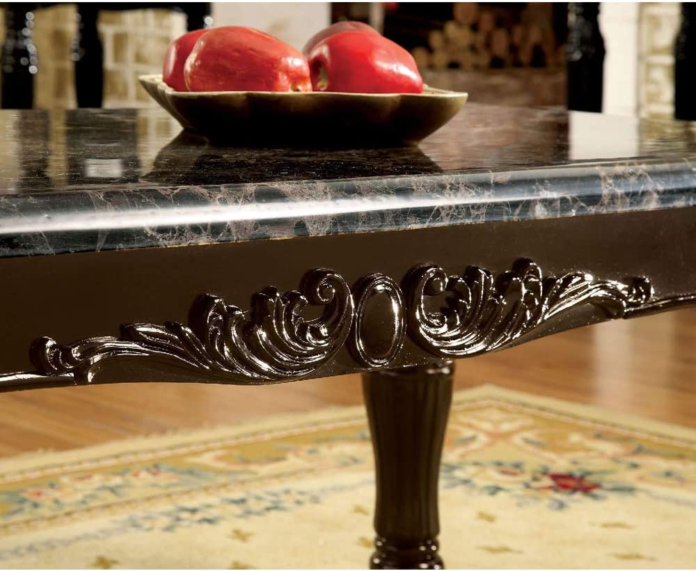 Elegant black marble dining table with ornate carved apron detail