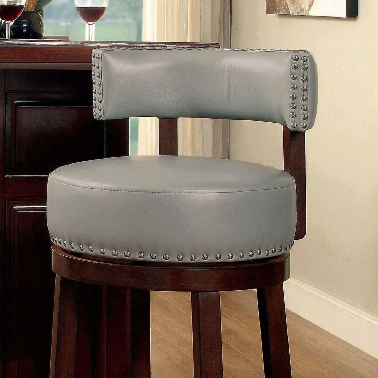 Tufted grey leather bar stool with nailhead trim and mahogany finish