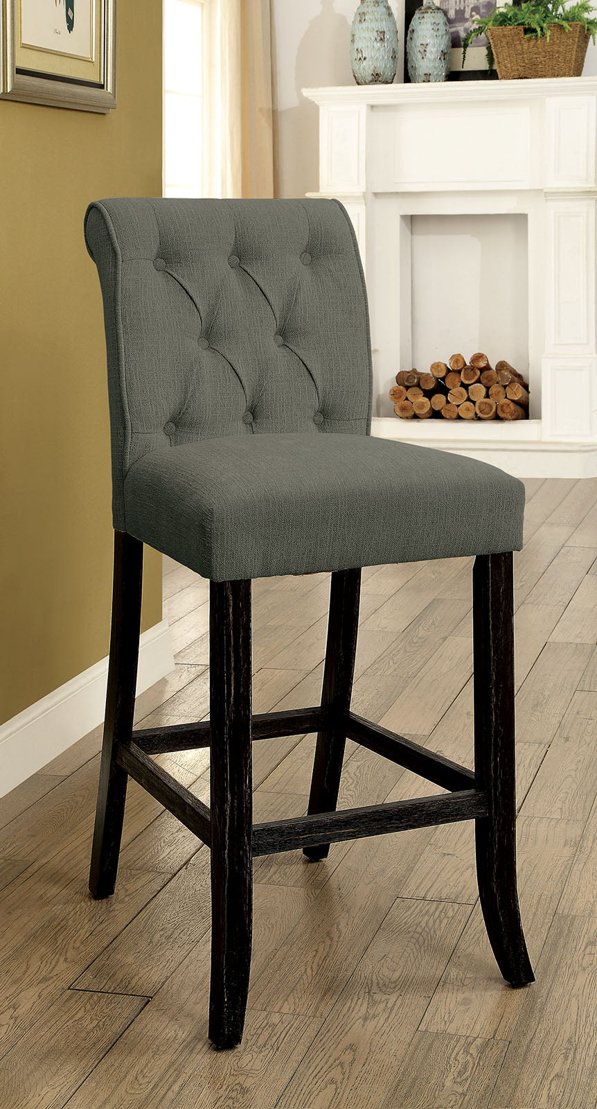 Grey upholstered tufted bar stool with dark wooden legs