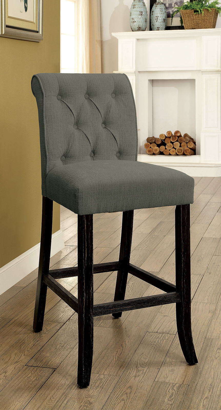 Tufted grey fabric bar stool with dark wood legs and a curved back