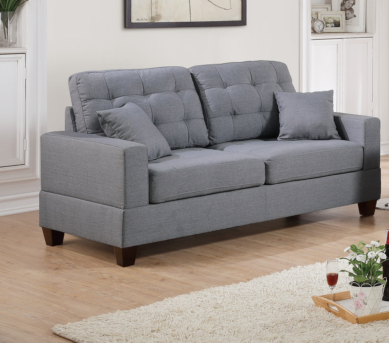 Modern grey upholstered loveseat with tufted back cushions