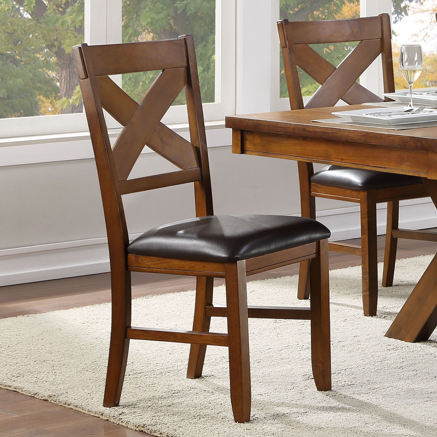 Rich brown wooden dining chair with dark faux leather seat and crisscross back