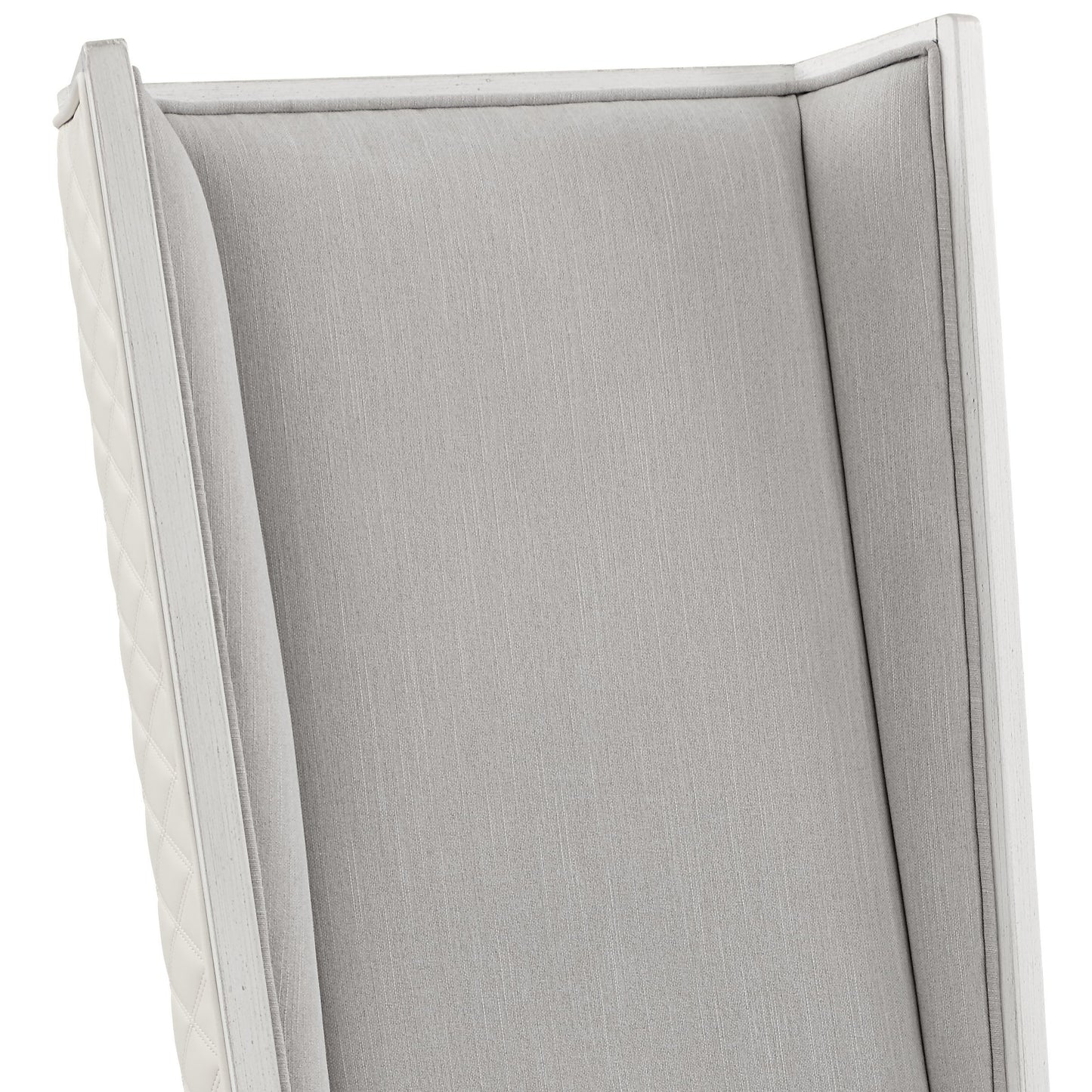 Elegant grey upholstered accent chair with white wooden trim and quilted side panels