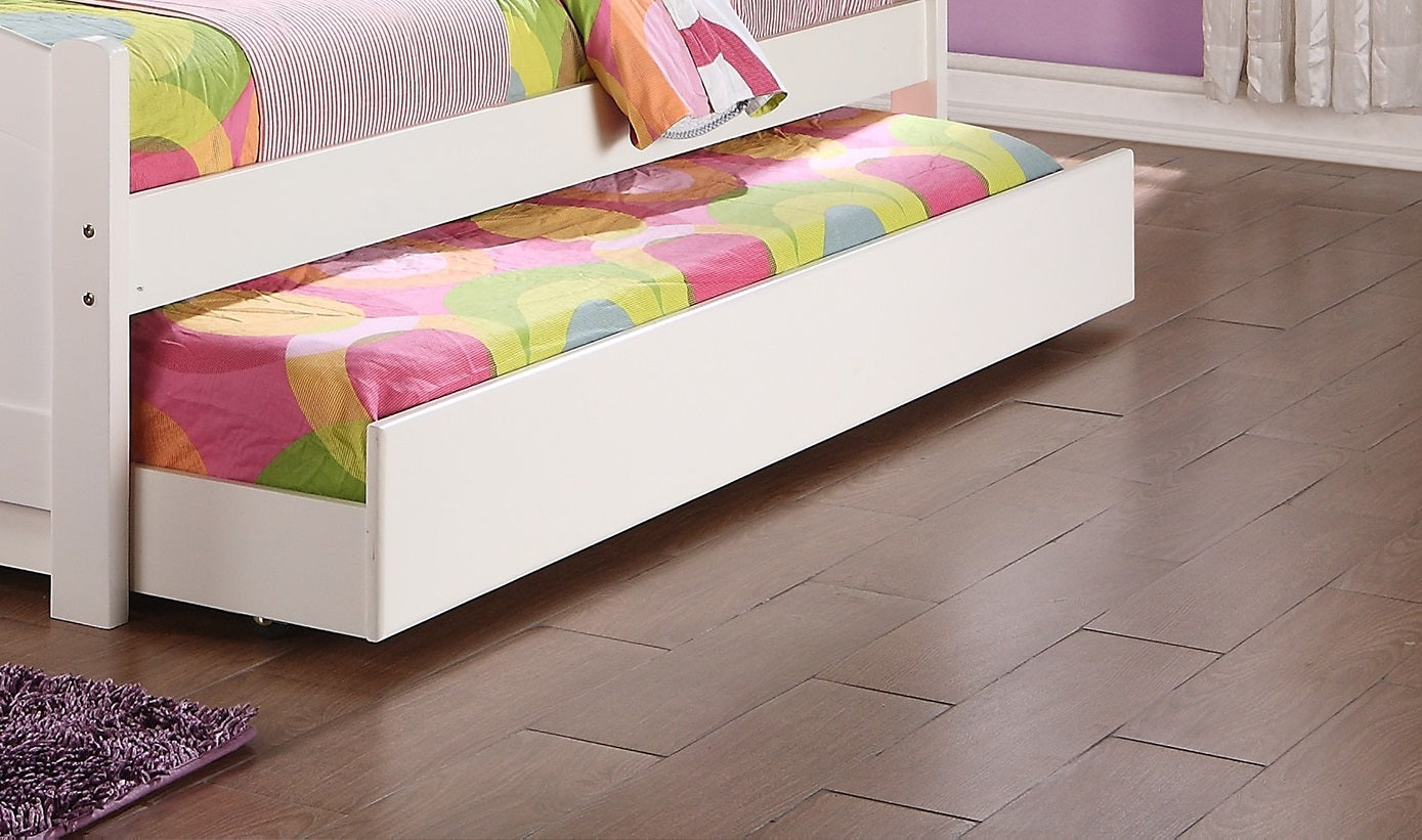White wooden toddler bed with pullout trundle featuring colorful abstract bedding