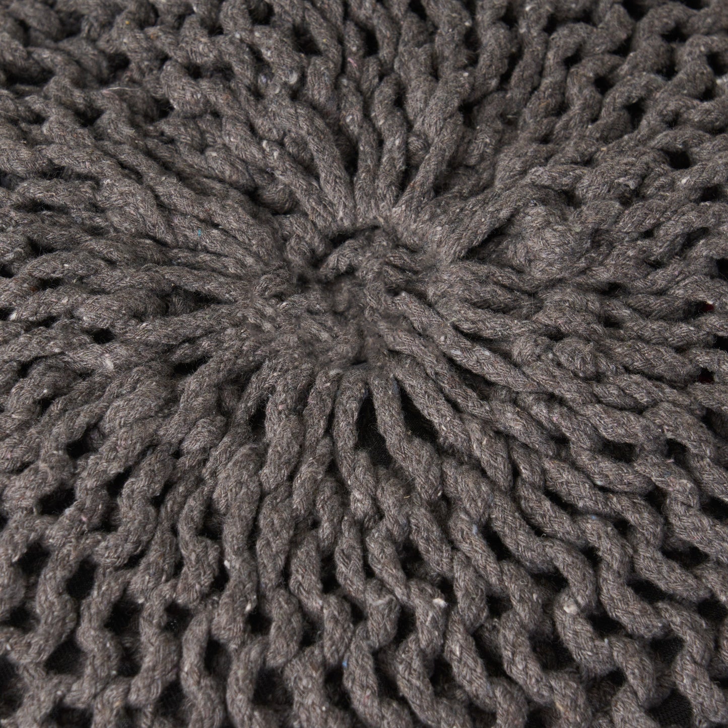 Closeup of thick charcoal grey knit yarn texture with visible loops and stitches