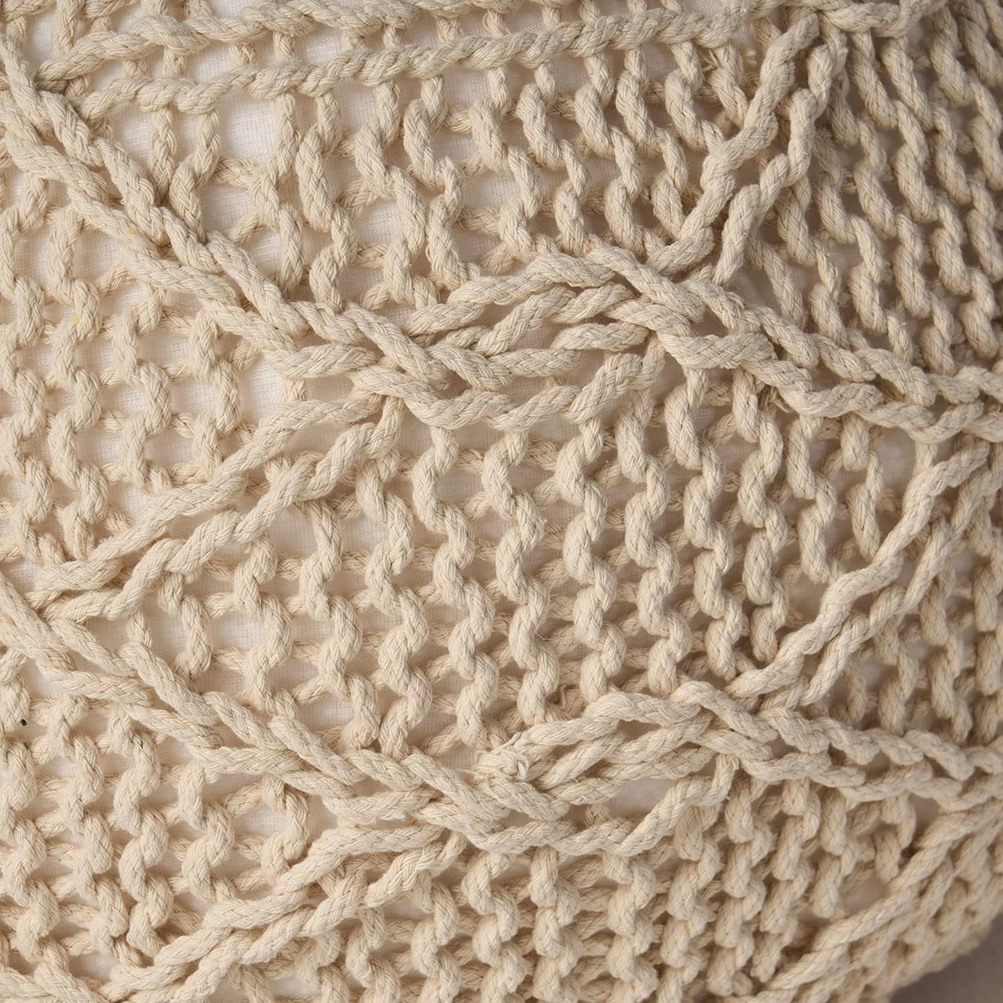 Closeup of beige macrame weave detail on textured fabric for home decor