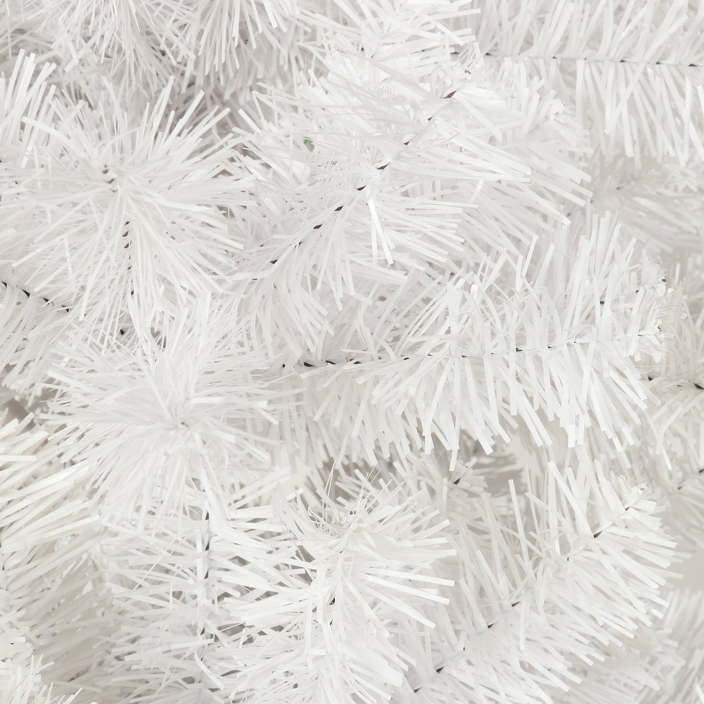 Closeup of a fluffy white artificial Christmas tree branch perfect for festive decor