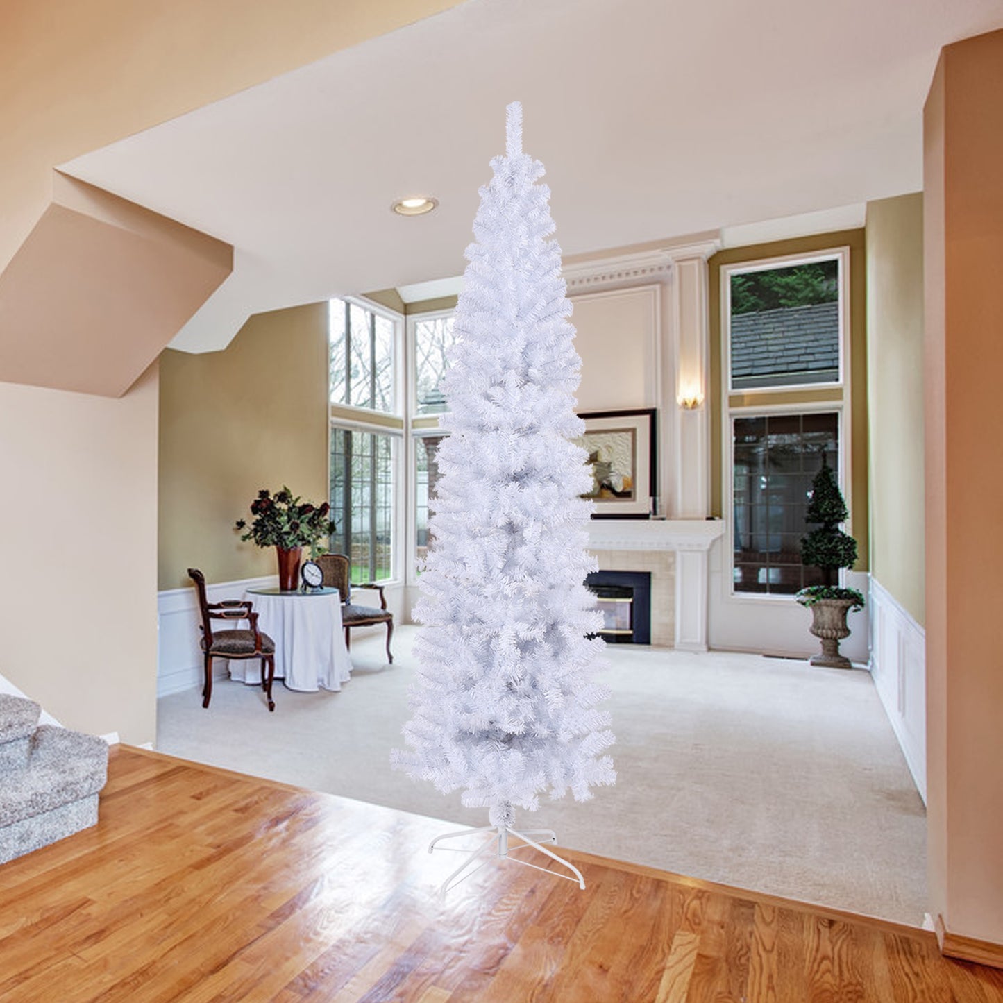 Tall slender white artificial Christmas tree with full branches set in a bright living room