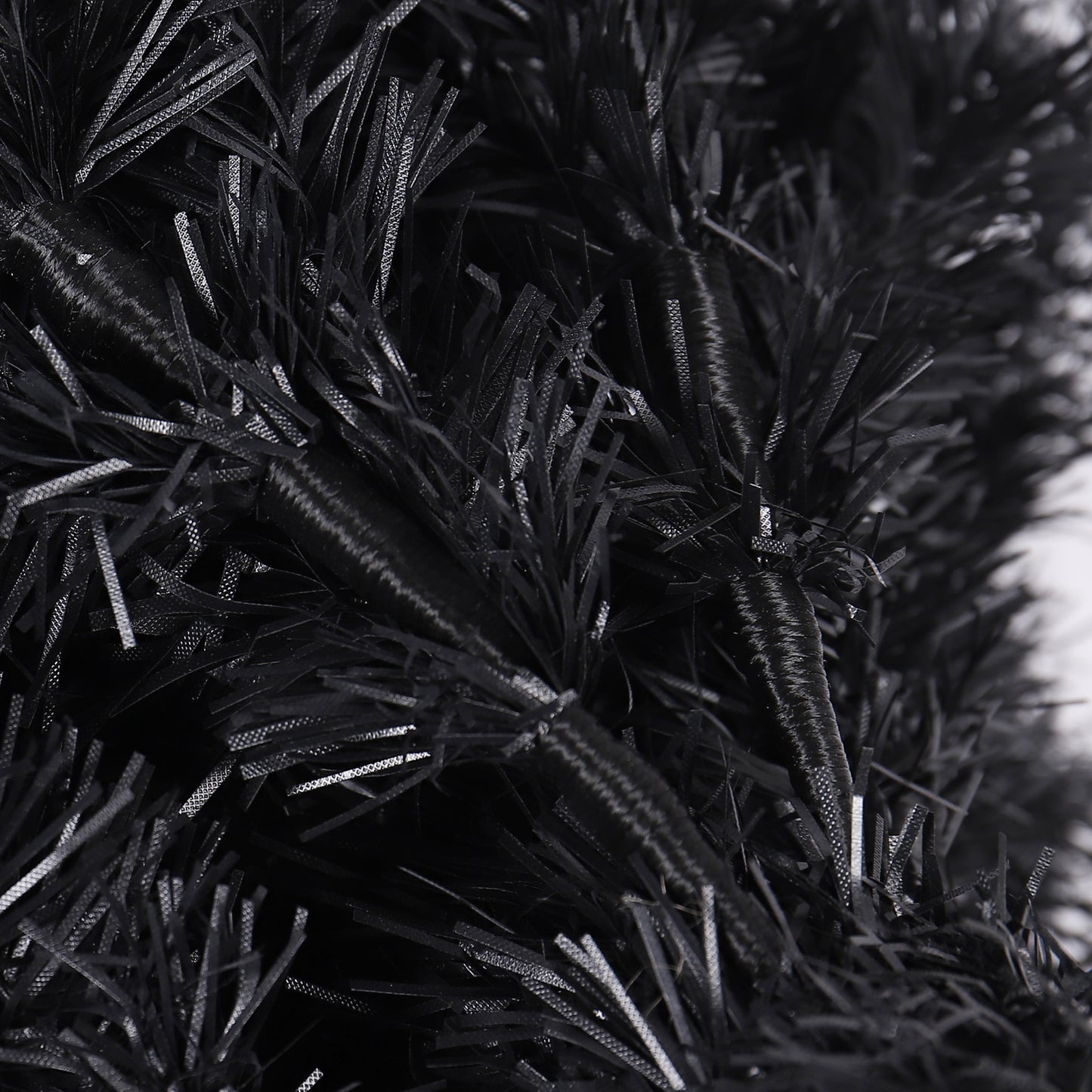 Closeup of a black artificial Christmas garland with tinsel branches