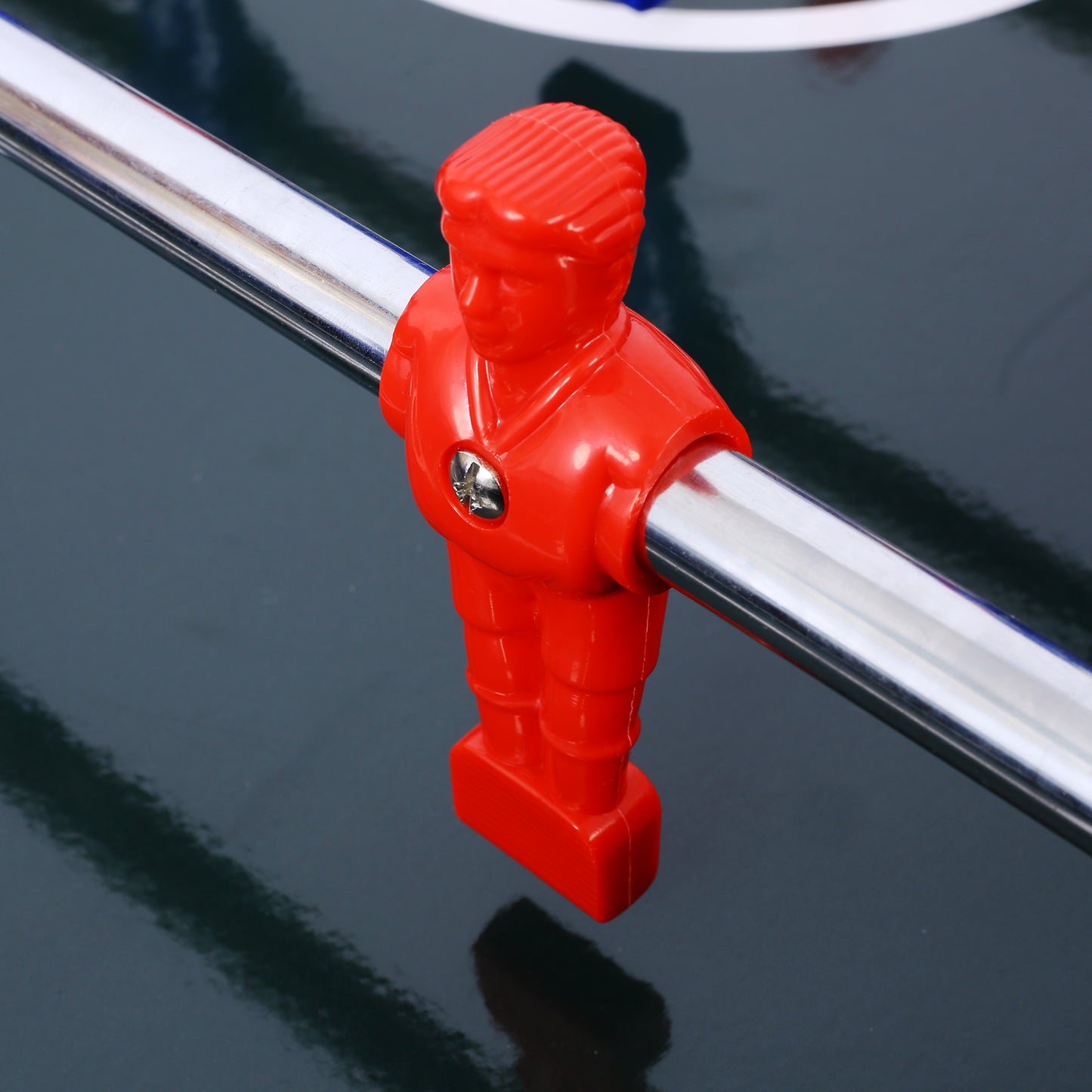 Red plastic foosball player figure on a shiny silver rod essential for game enjoyment