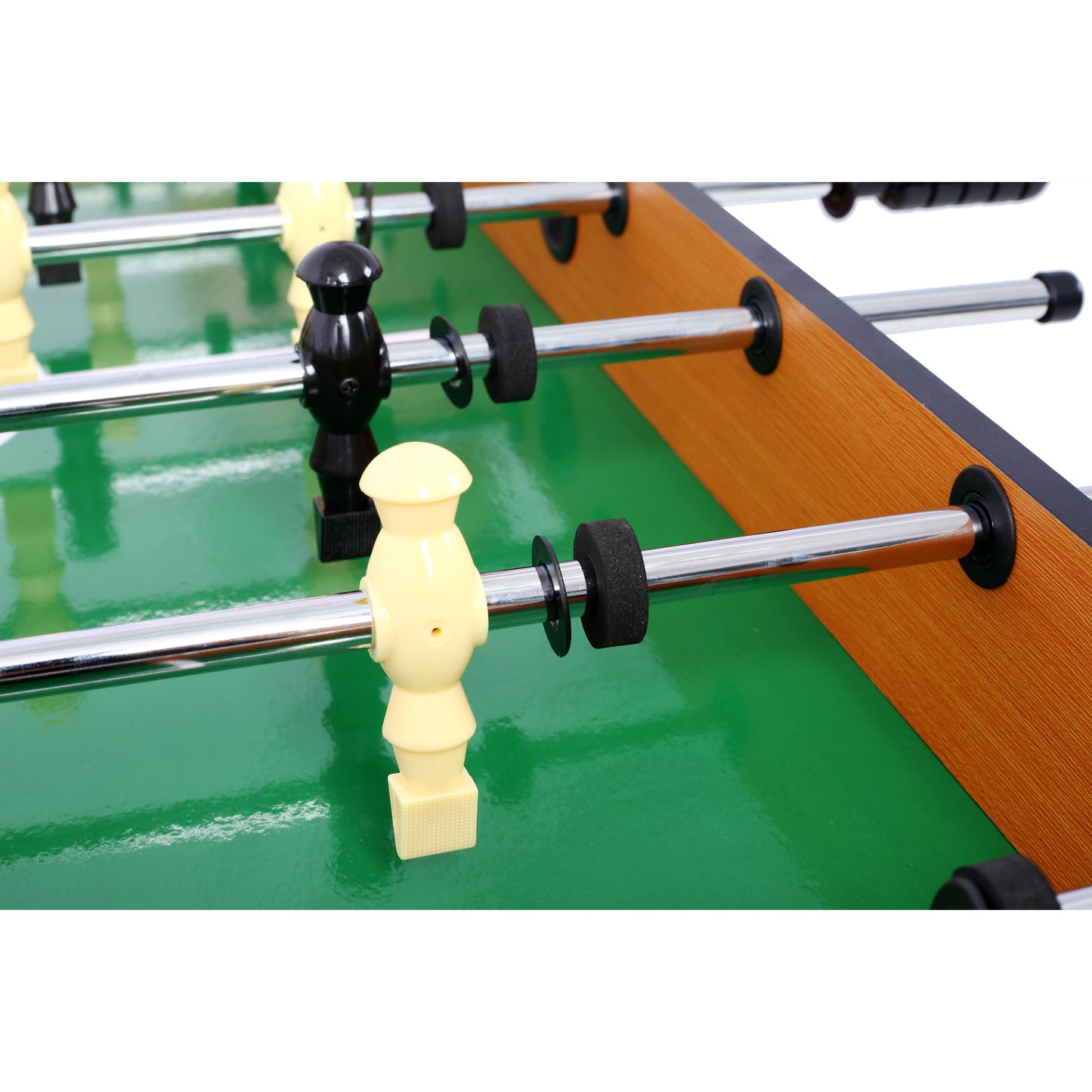 Closeup of yellow and black foosball players on a green field ready for a game