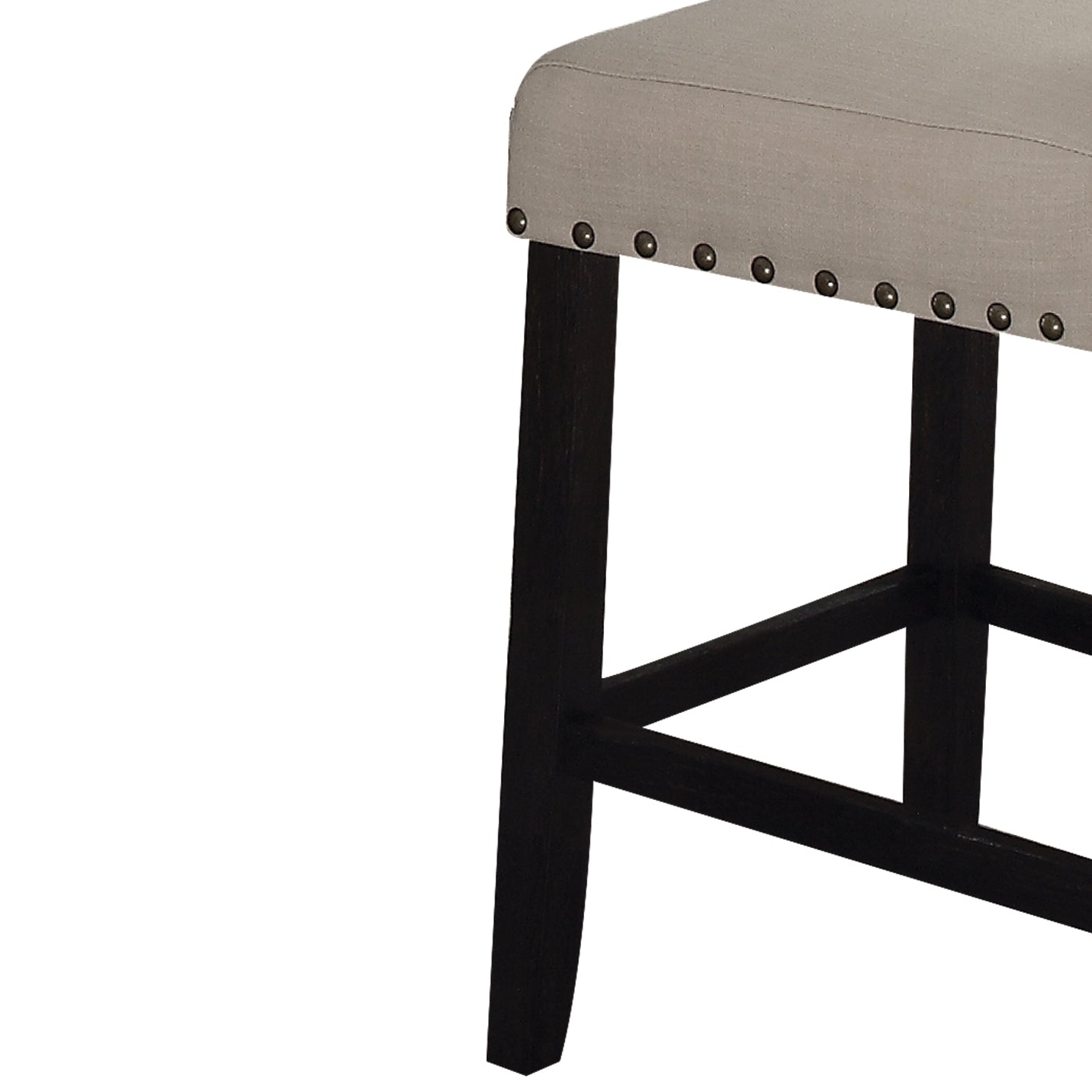 Closeup of a beige upholstered bar stool with nailhead trim and dark wood legs
