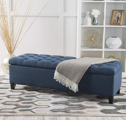 Tufted navy storage bench with a grey throw blanket for living room seating
