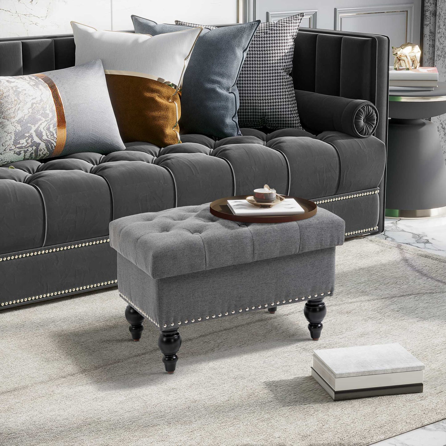 Tufted grey fabric storage ottoman with decorative nailhead trim and dark wood legs