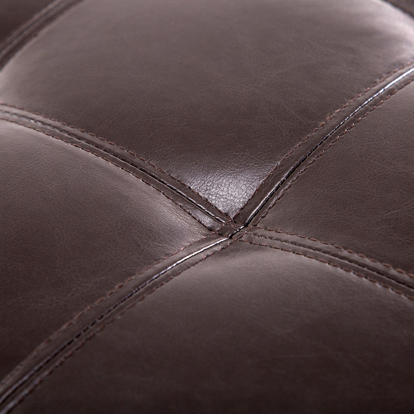 Brown faux leather tufted ottoman detail showing diamond stitching pattern