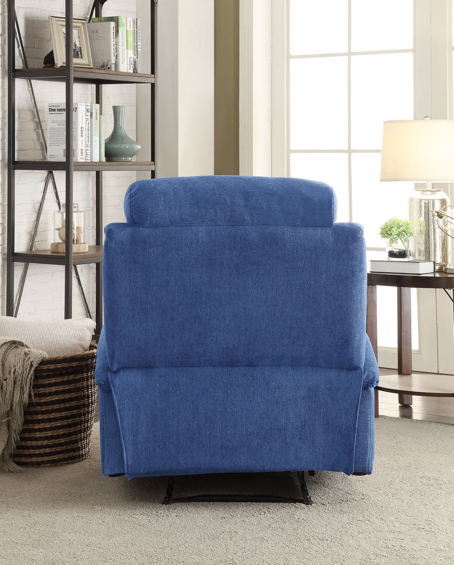 Back view of a plush blue fabric recliner chair with padded headrest