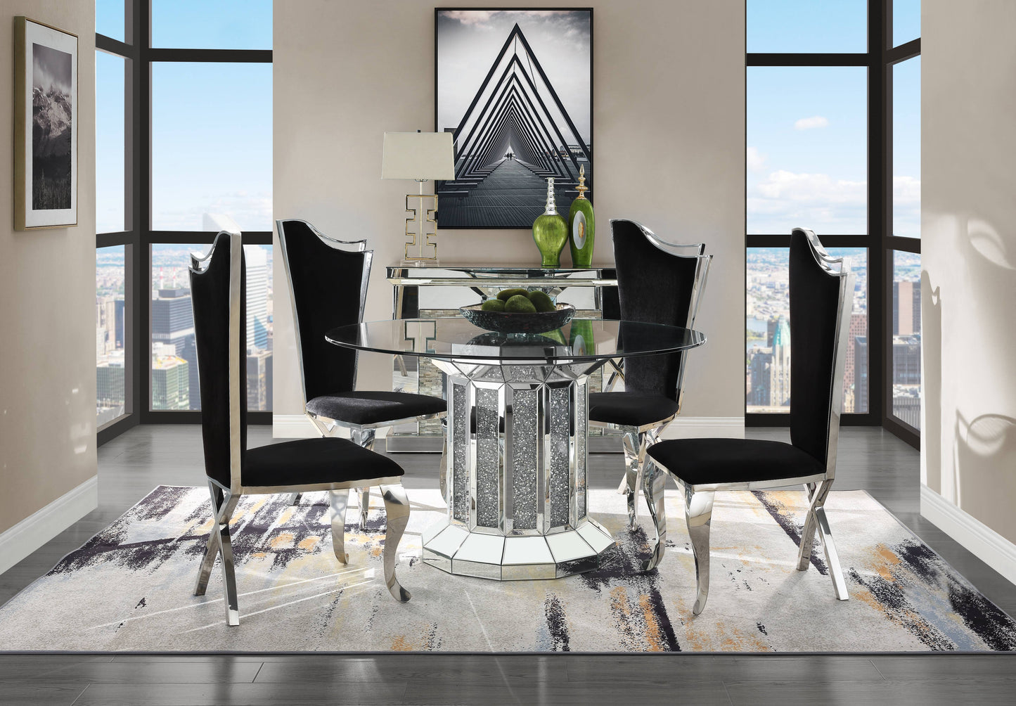 Round glass dining table with crushed crystal pedestal and four black velvet chairs