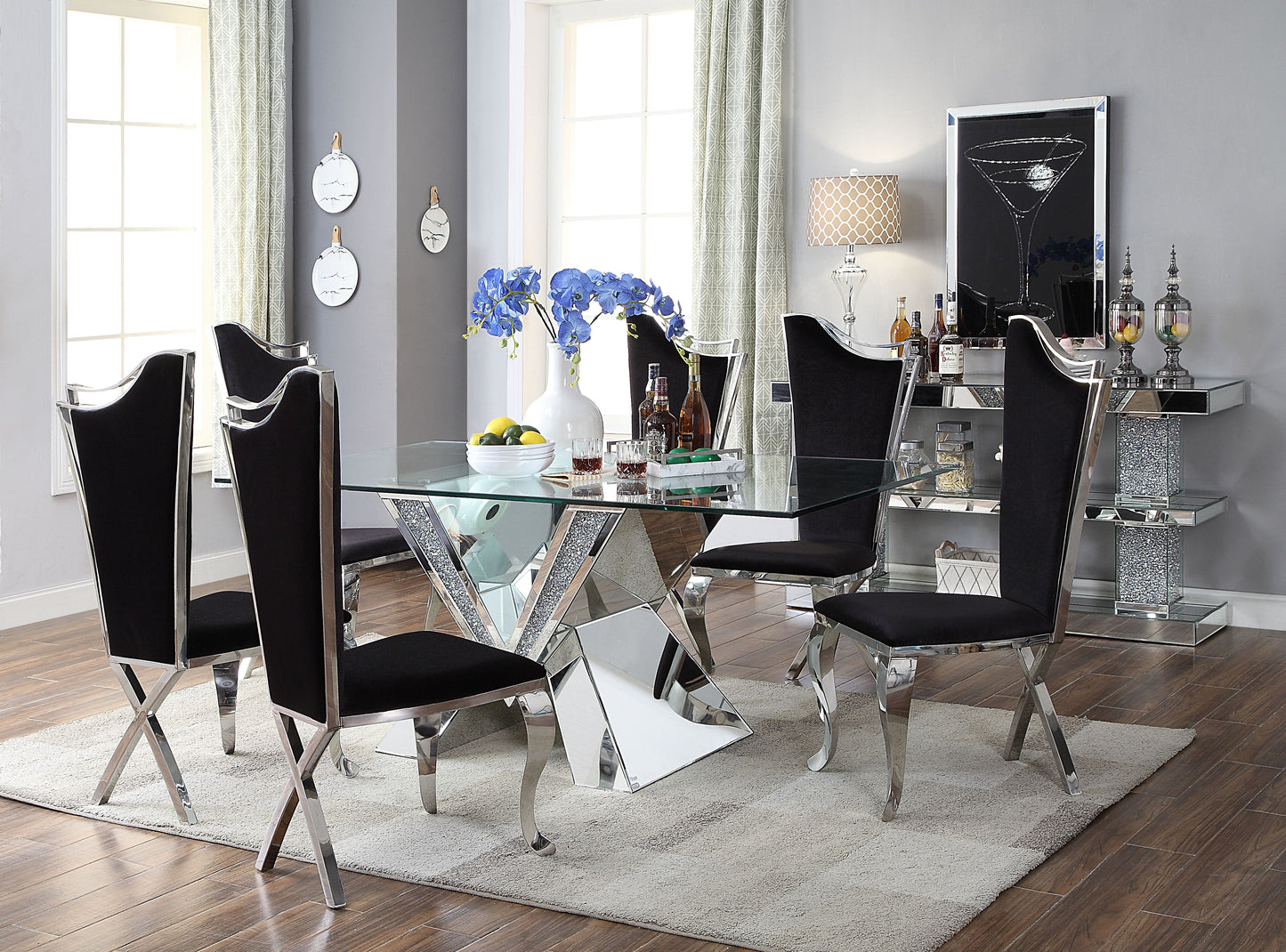 Glass top dining table with silver mirrored base and black velvet chairs