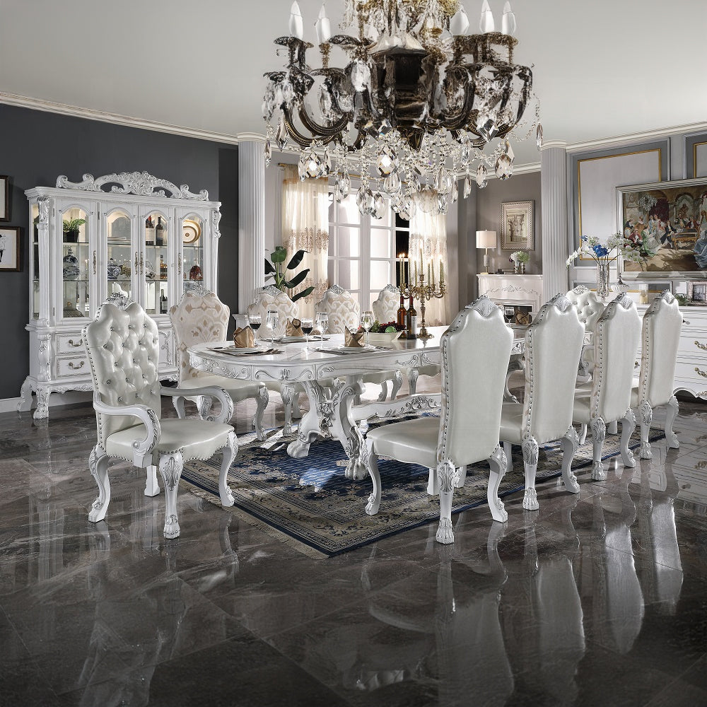 White tufted dining chair with silver accents and ornate legs
