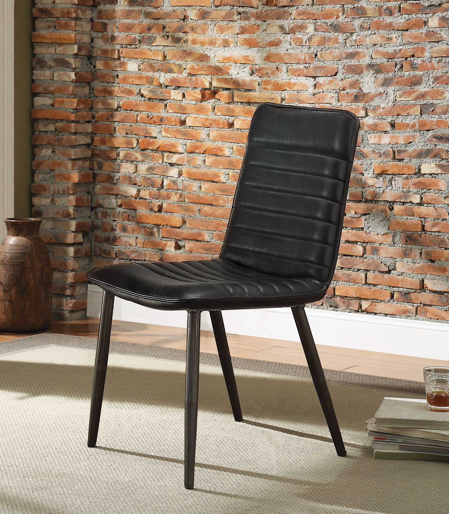 Black upholstered dining chair with channel tufting and dark metal legs