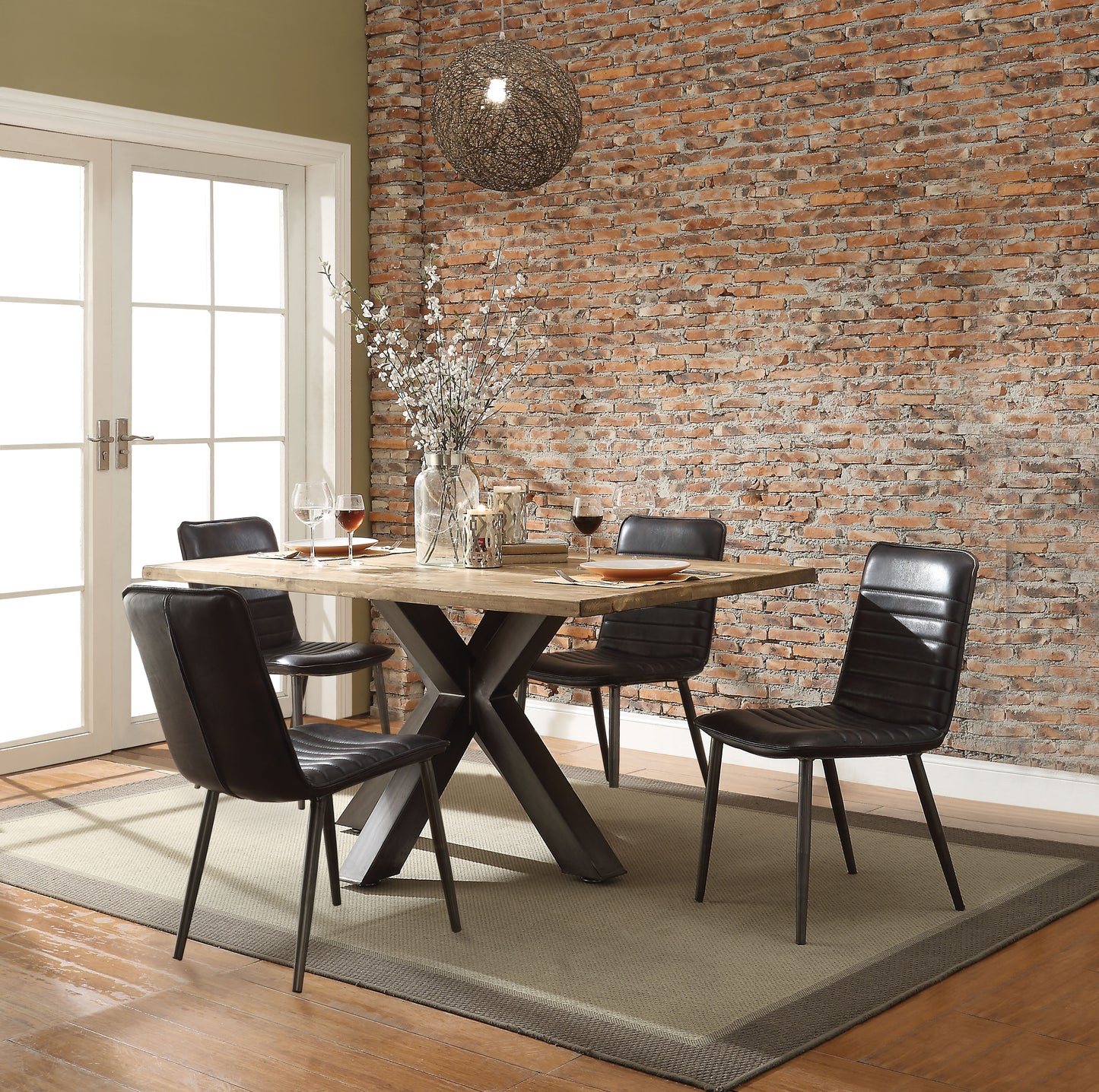 Rustic wooden dining table with industrial metal base and black upholstered chairs