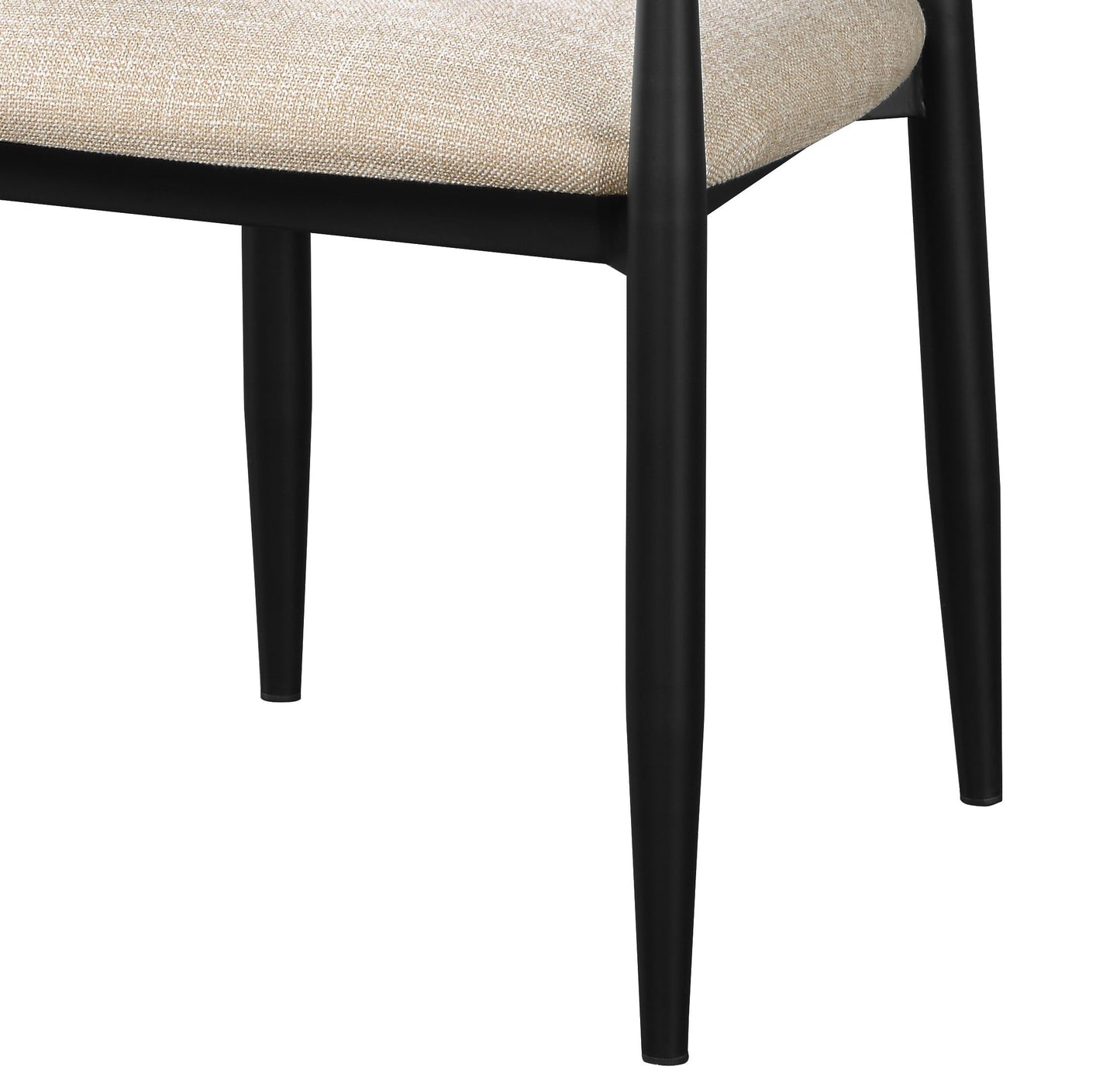 Close up of black metal tapered legs on a neutral textured fabric chair