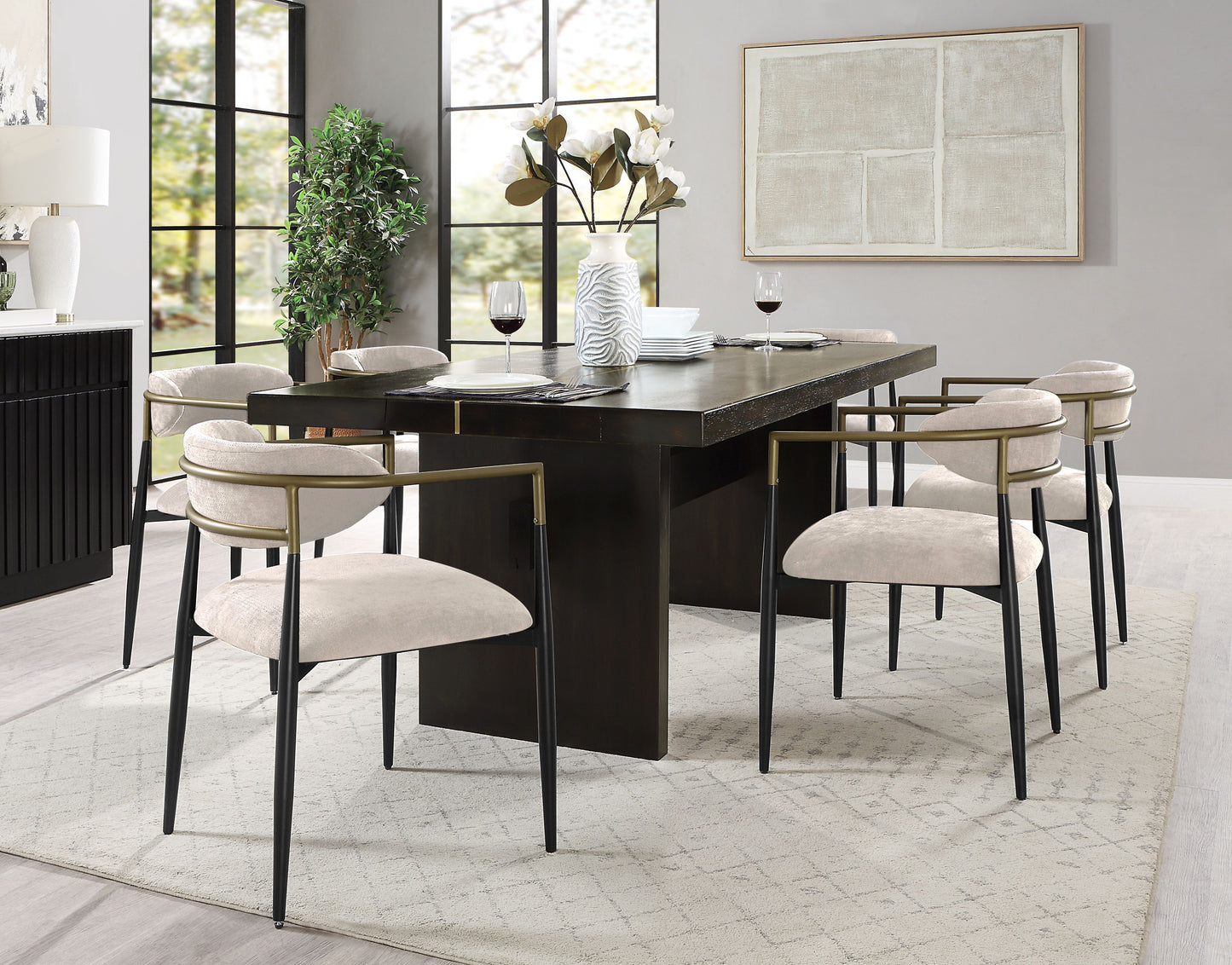 Modern dining chairs in beige fabric with gold and black metal frames perfect for a contemporary dining room