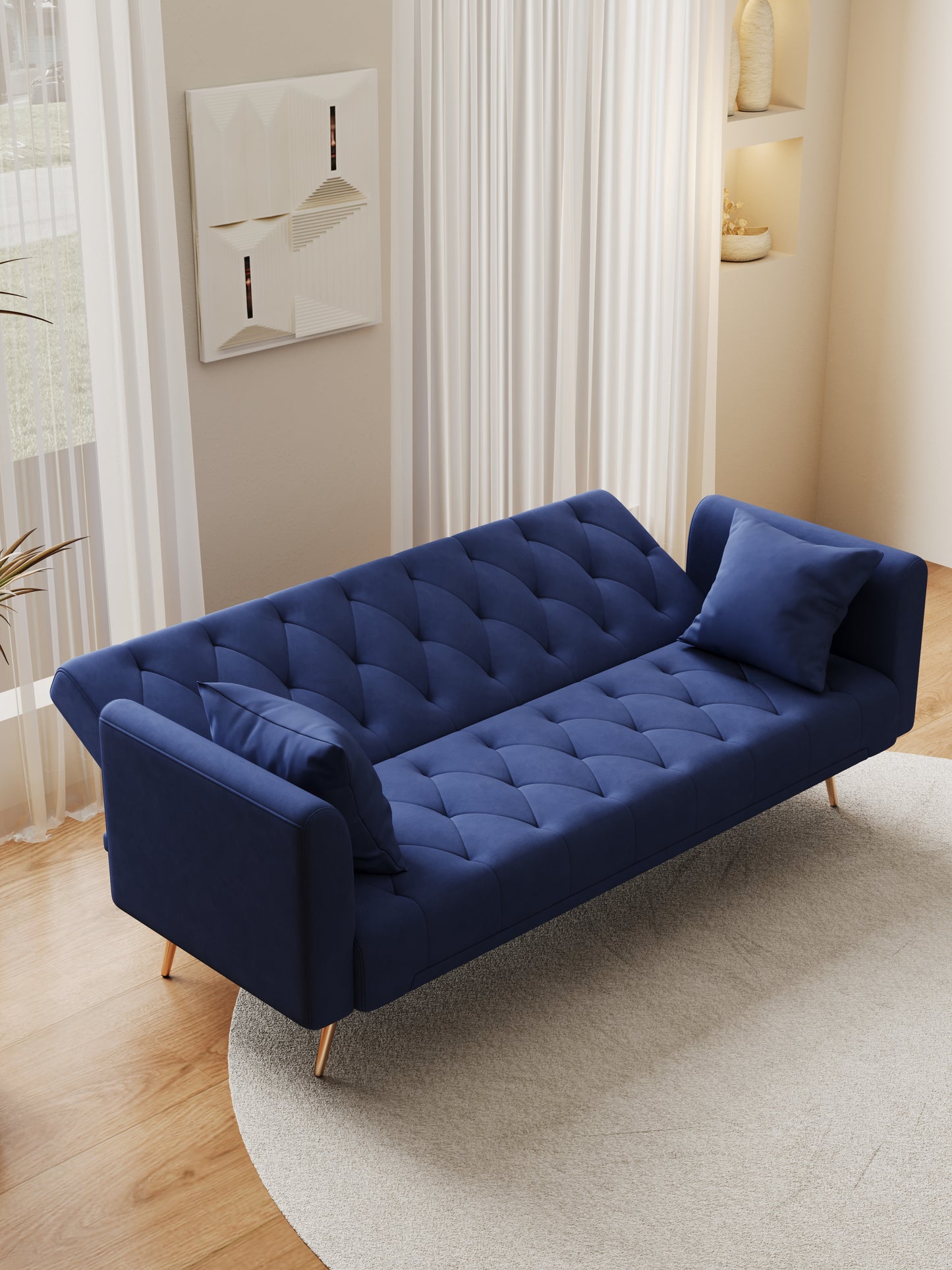 Tufted navy blue velvet sofa with gold legs ideal for living rooms