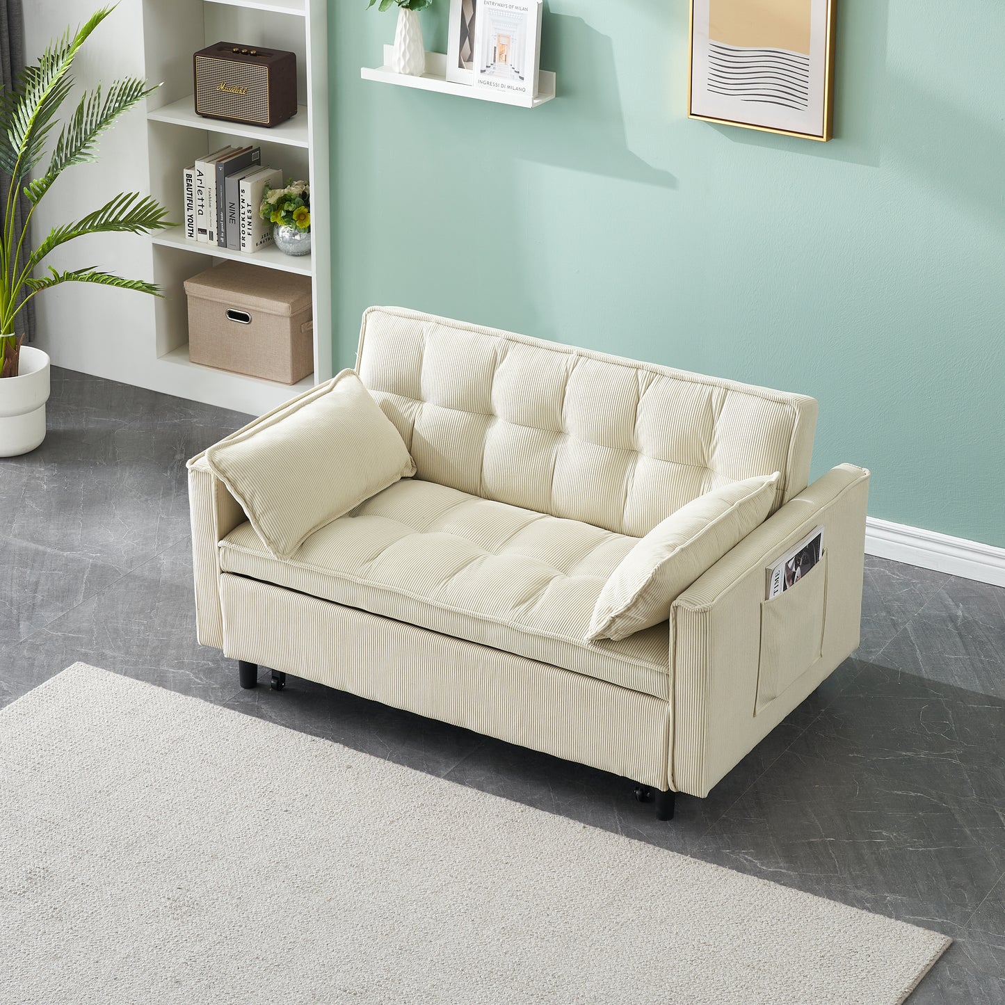 Cream corduroy sofa bed with tufted cushions and two throw pillows