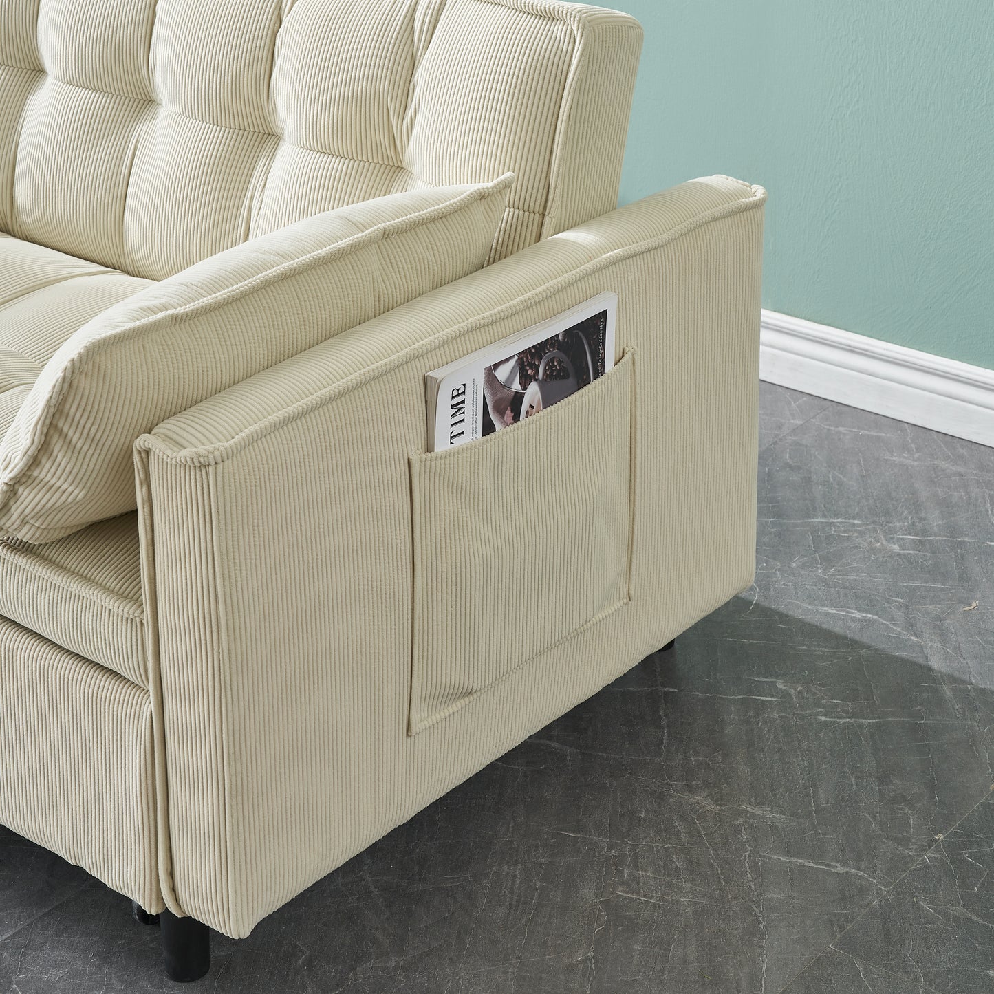 Cream corduroy sofa armrest with a builtin magazine pocket and a magazine