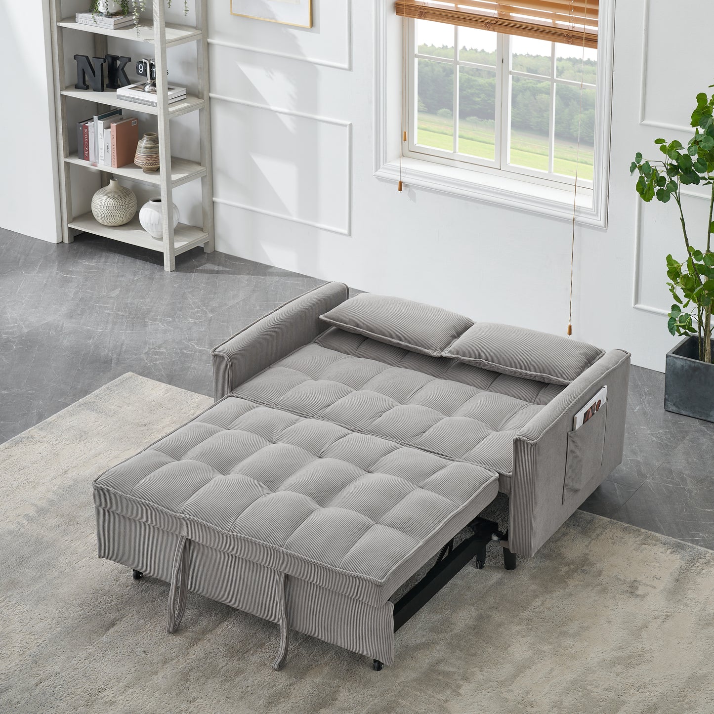 Gray corduroy sofa bed with tufted cushions and pull tabs for adjustment