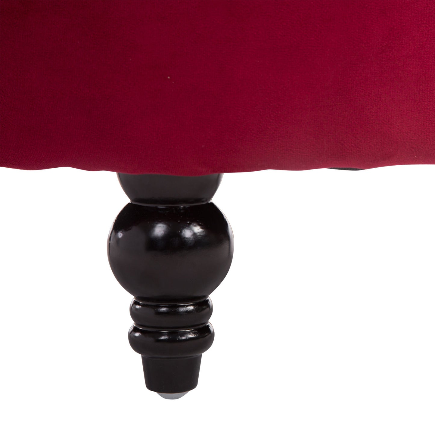 Deep red upholstered ottoman with a carved dark wood leg detail