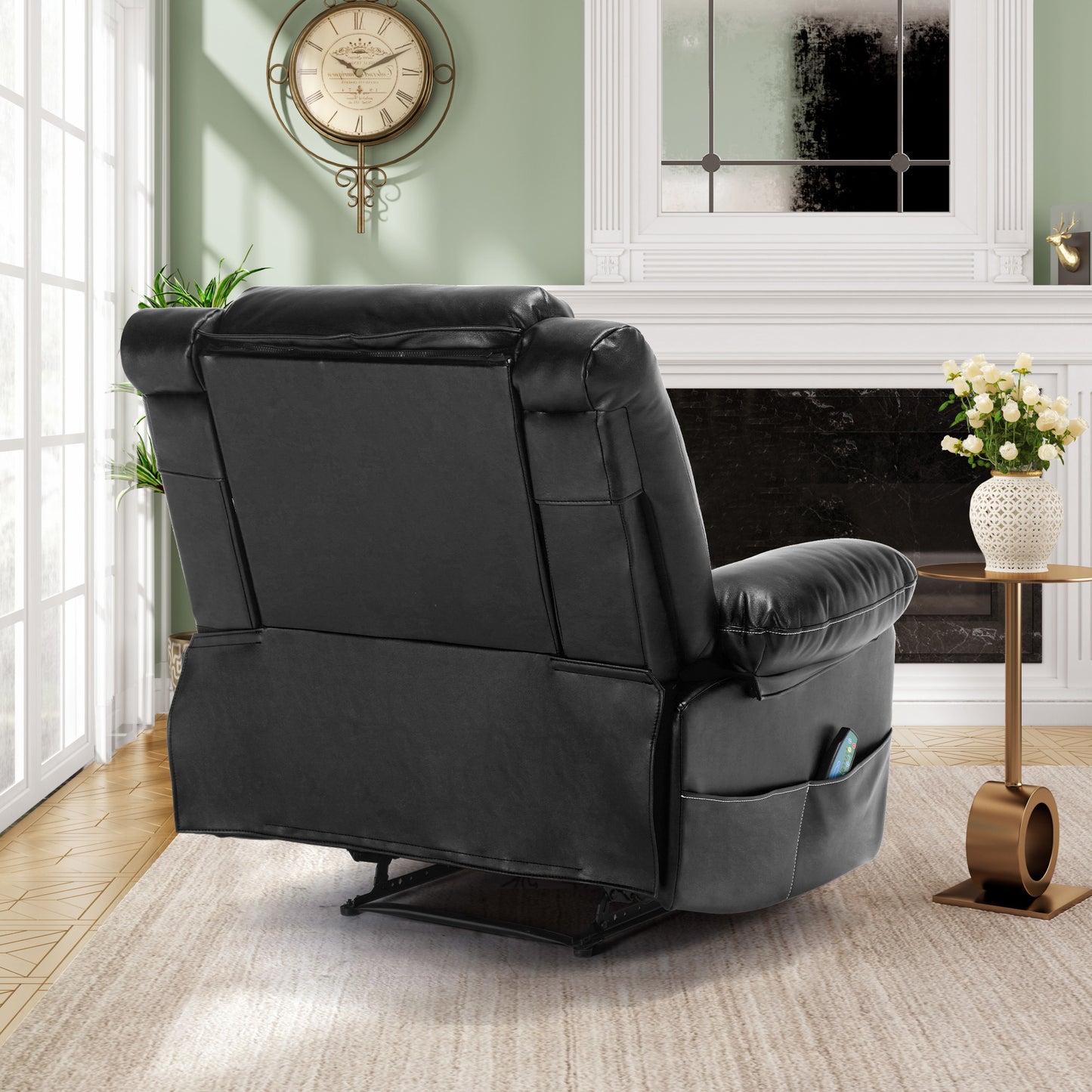 Black leather recliner chair with white stitching and side pocket holding remote