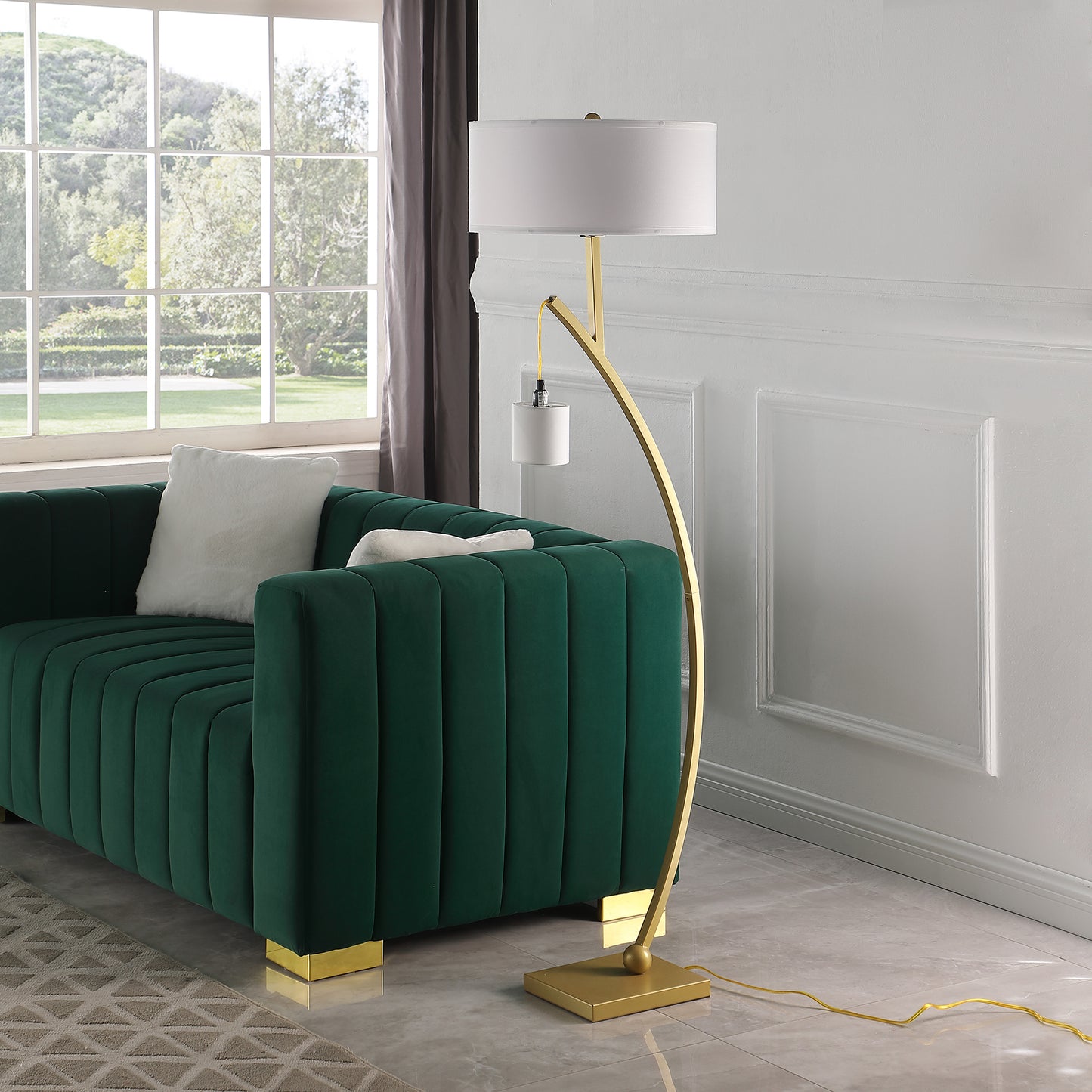 Modern arc floor lamp with white drum shade and brushed gold finish perfect for living rooms