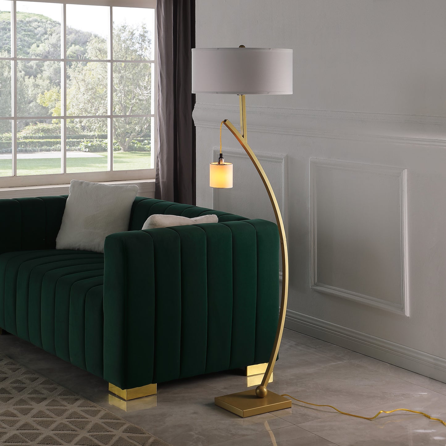 Modern gold arc floor lamp with a white drum shade and accent light
