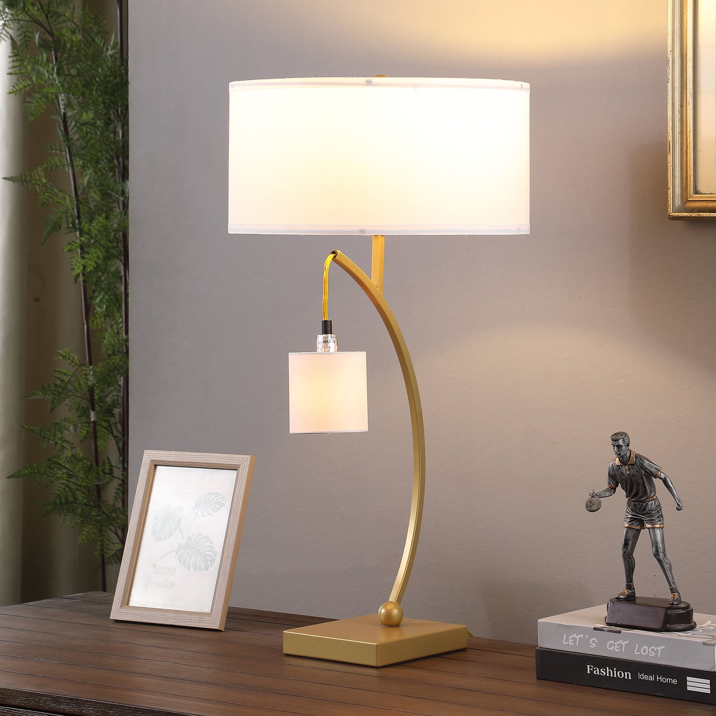 Gold modern desk lamp with white fabric shade and curved arm