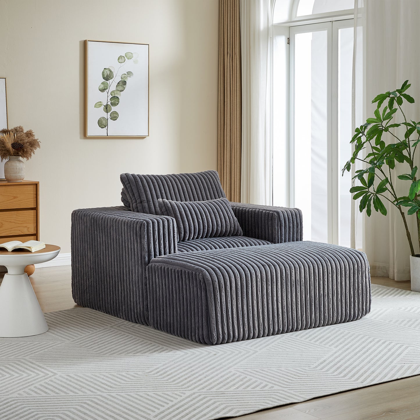 Plush grey corduroy armchair with matching ottoman perfect for a cozy living room
