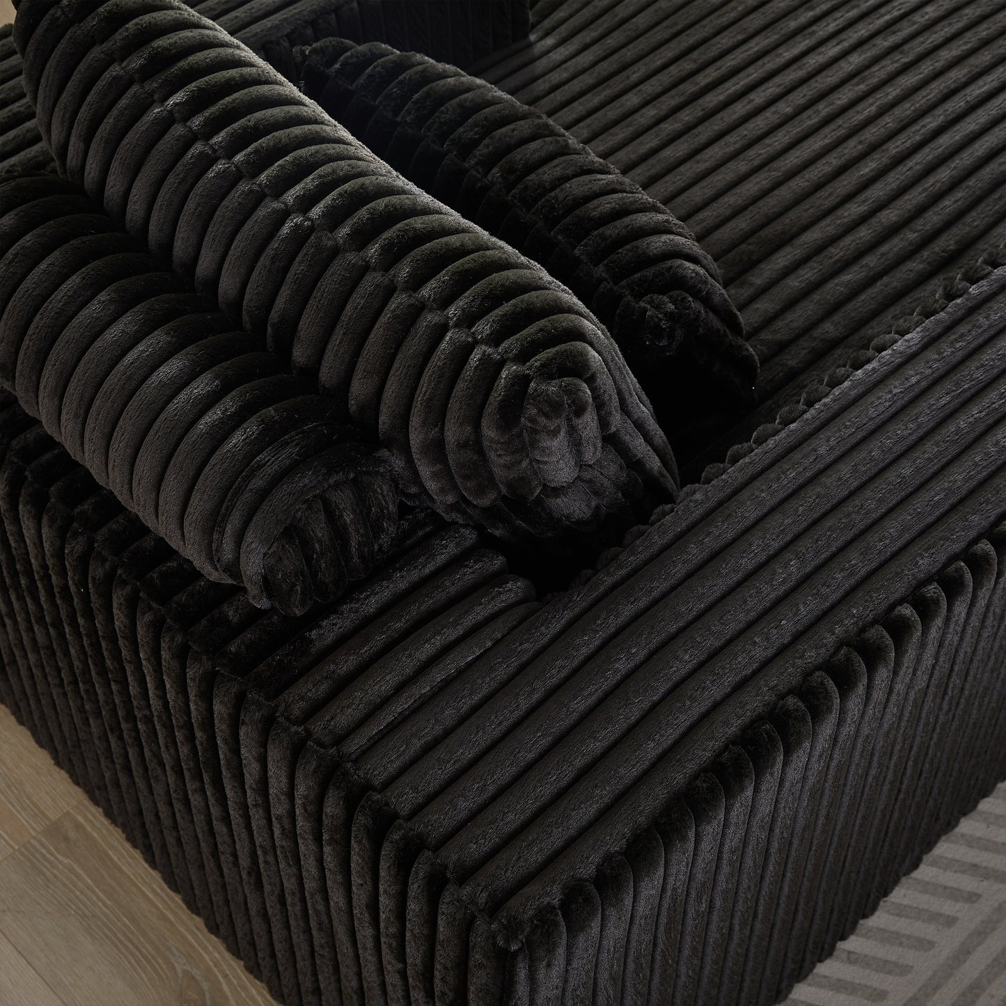 Black corduroy sofa cushions with plush texture and deep channels