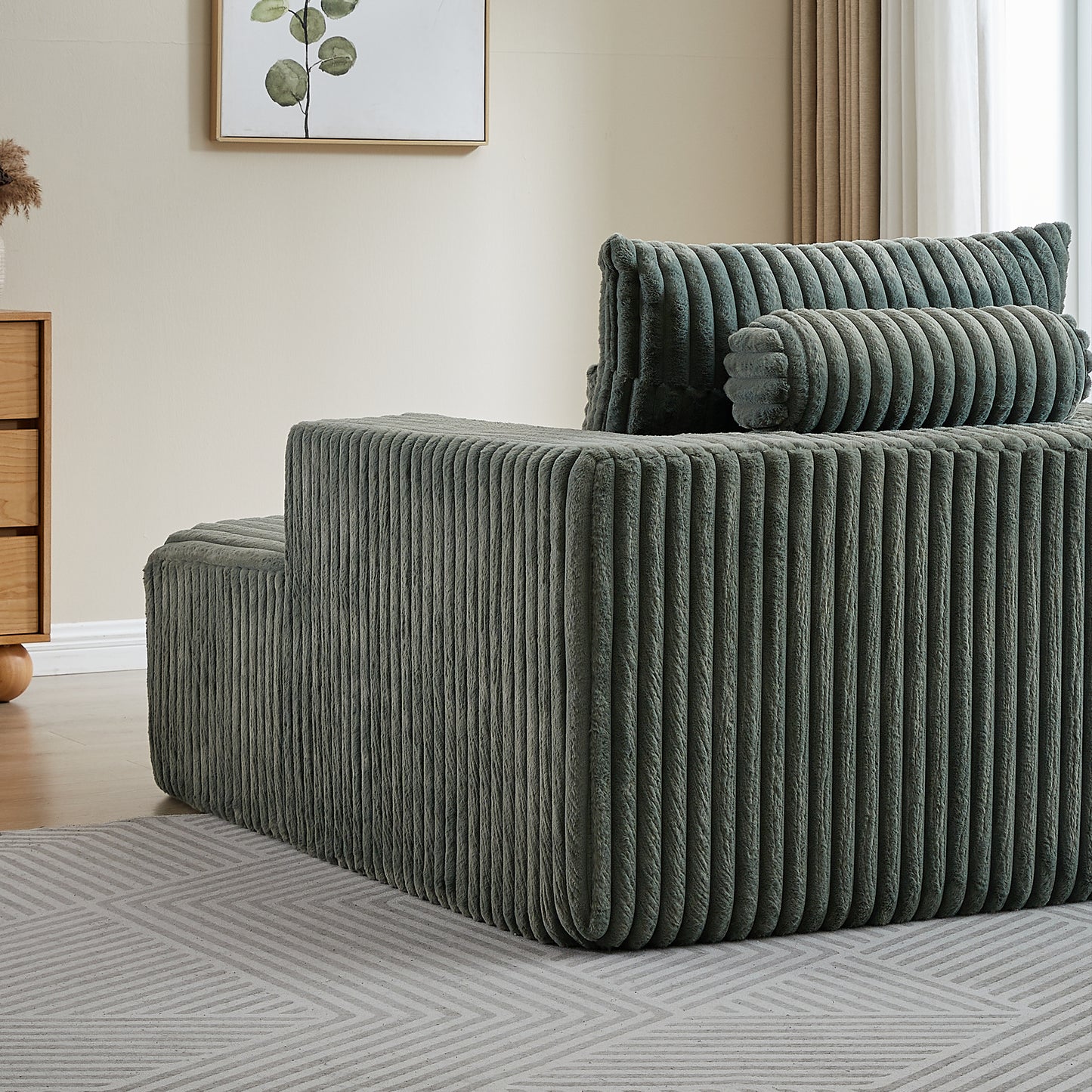 Plush corduroy sectional sofa in muted sage green featuring deep channel tufting
