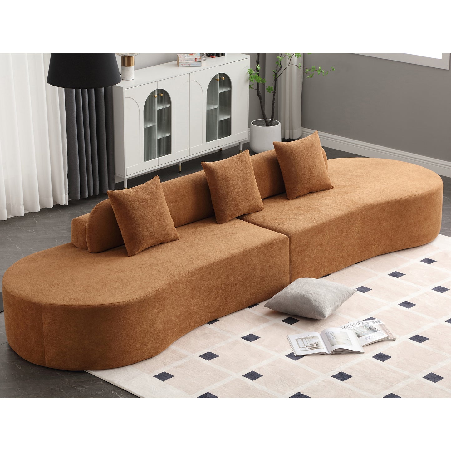 Curved modular sofa in rust fabric with matching throw pillows ideal for modern living rooms