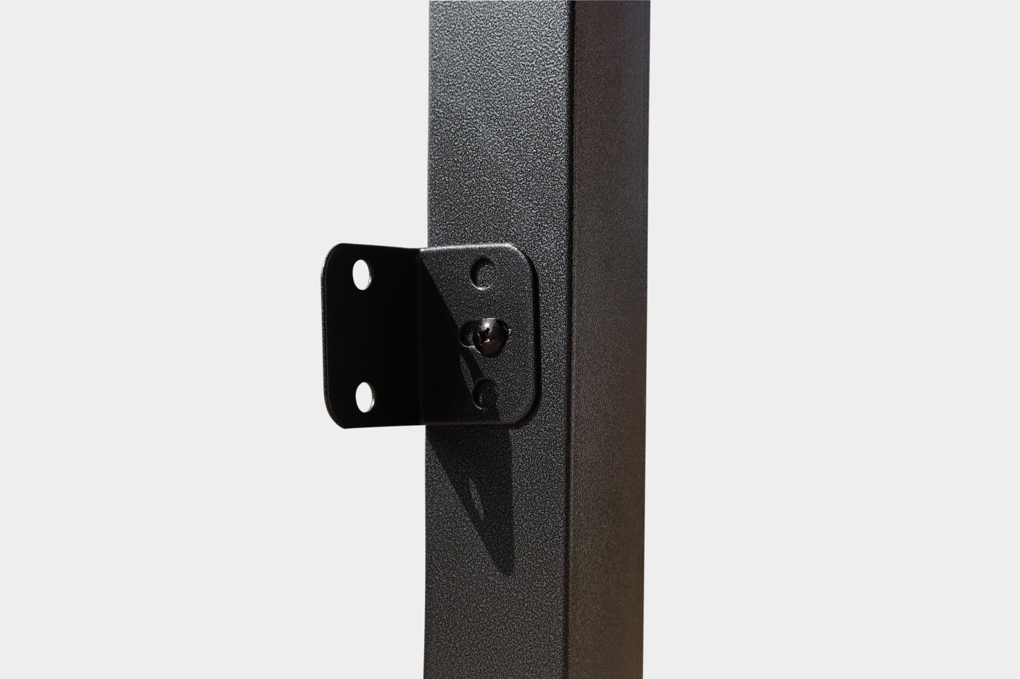 Black metal post with Lshaped bracket and screw for structural support