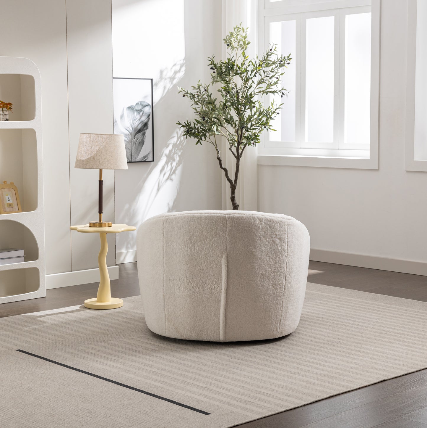 Plush cream round ottoman with textured fabric perfect for living room accent seating