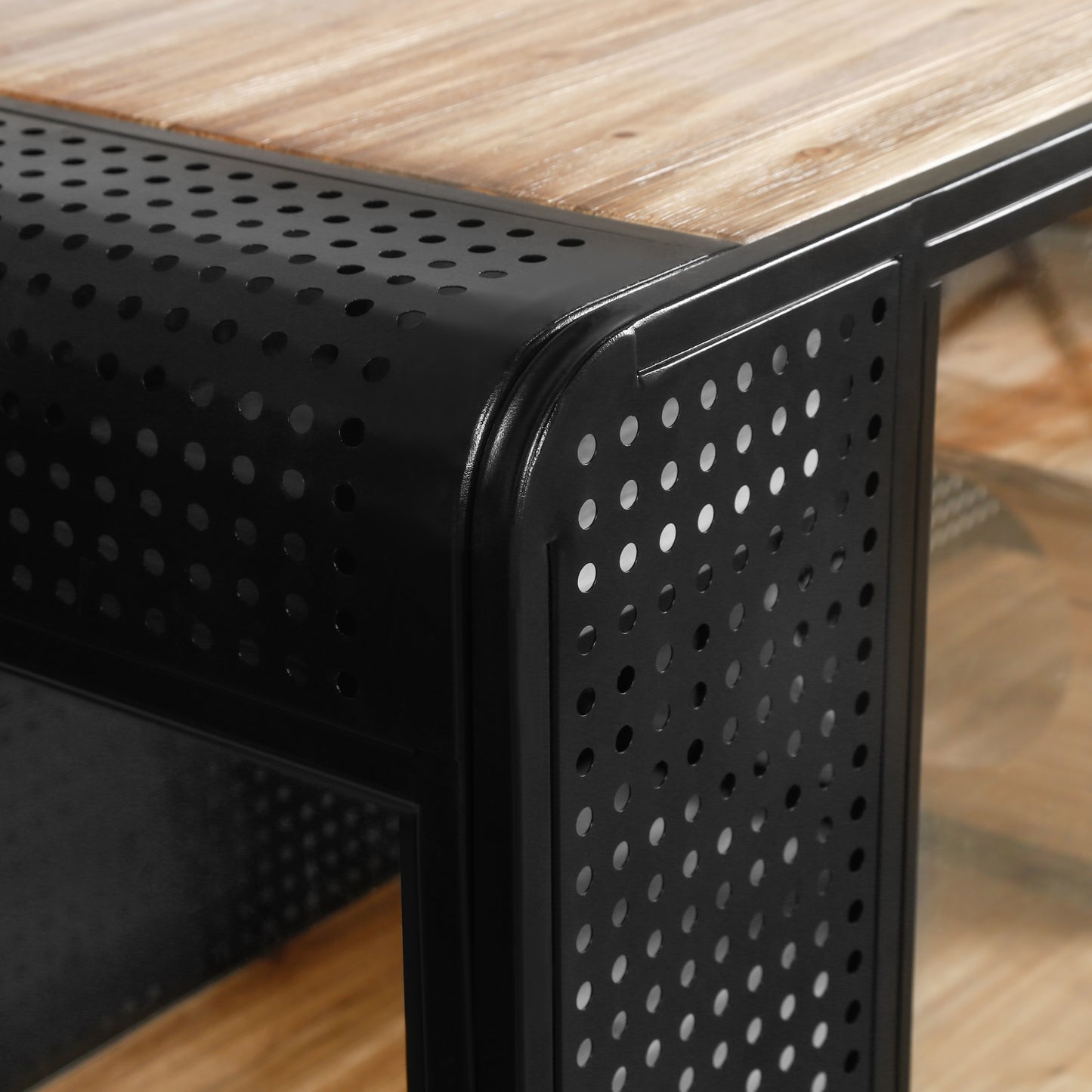 Closeup of a modern side table with a light wood top and perforated black metal frame