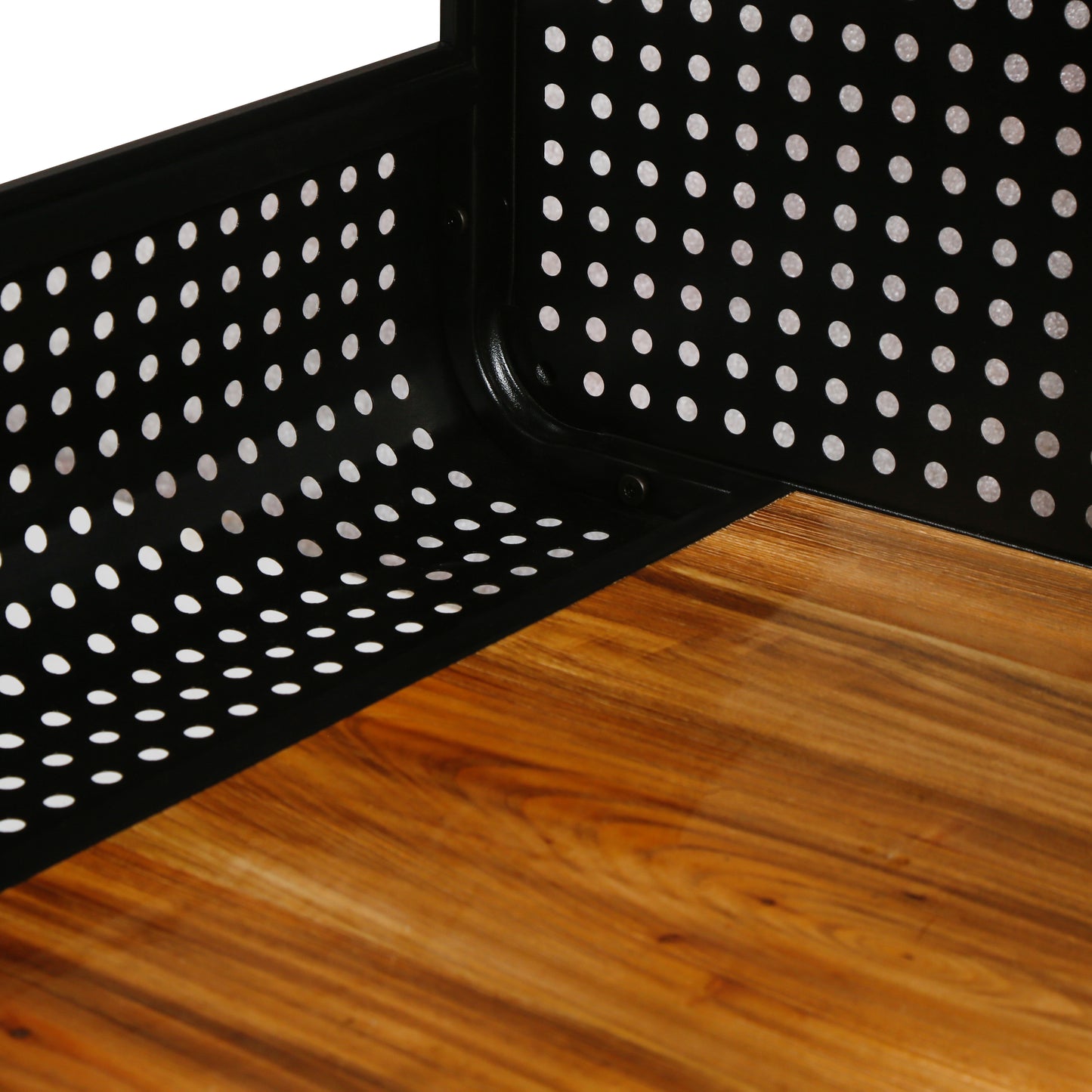Closeup of a black metal storage cart with a perforated side panel and a wooden shelf