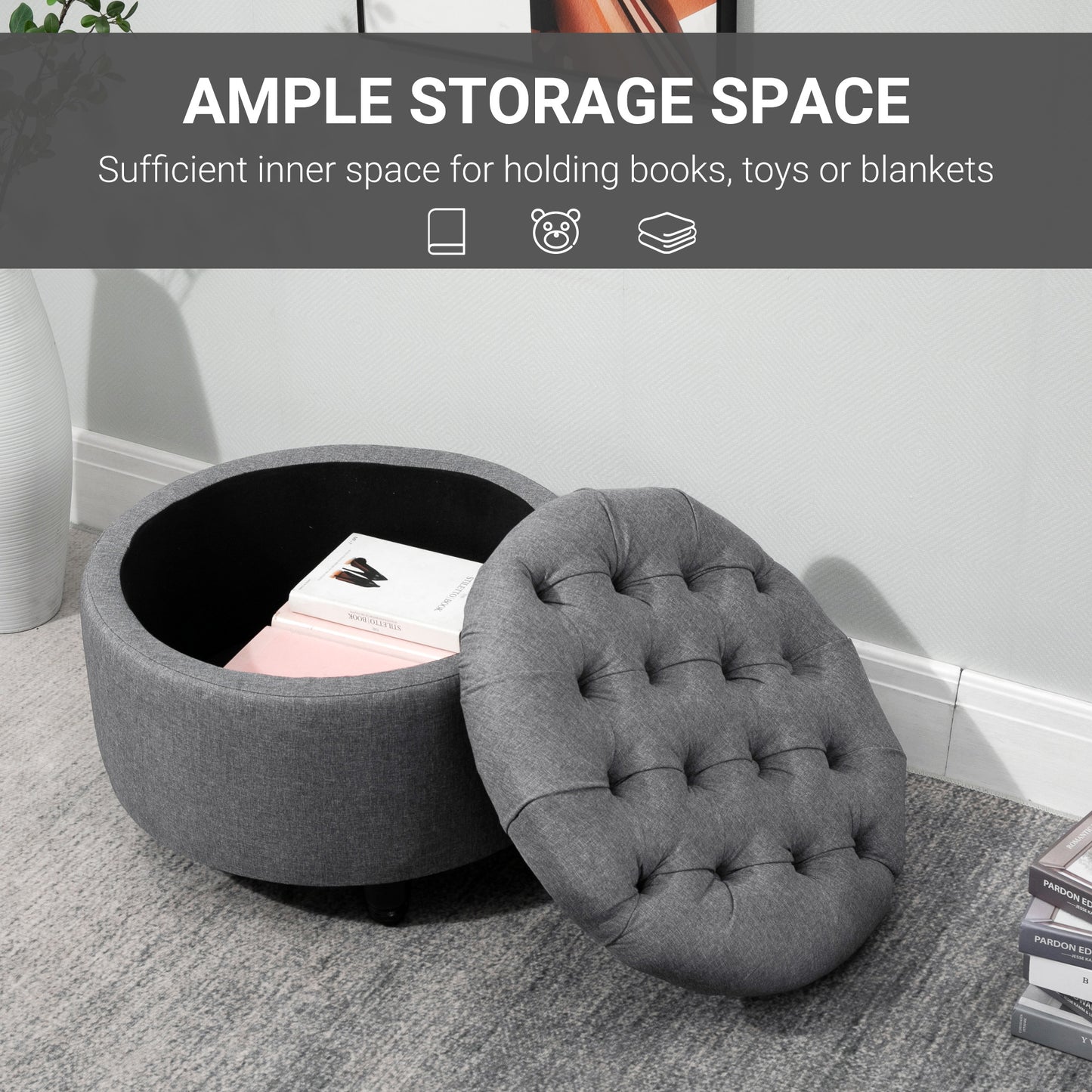 Gray fabric ottoman with tufted lid open revealing storage space for books