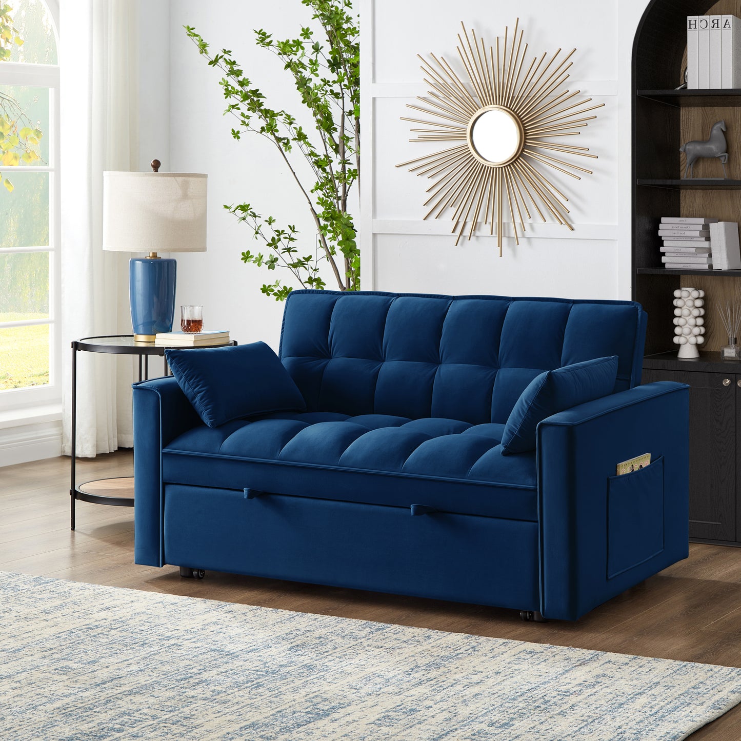Plush navy blue velvet sofa bed with tufted cushions and convenient side pocket
