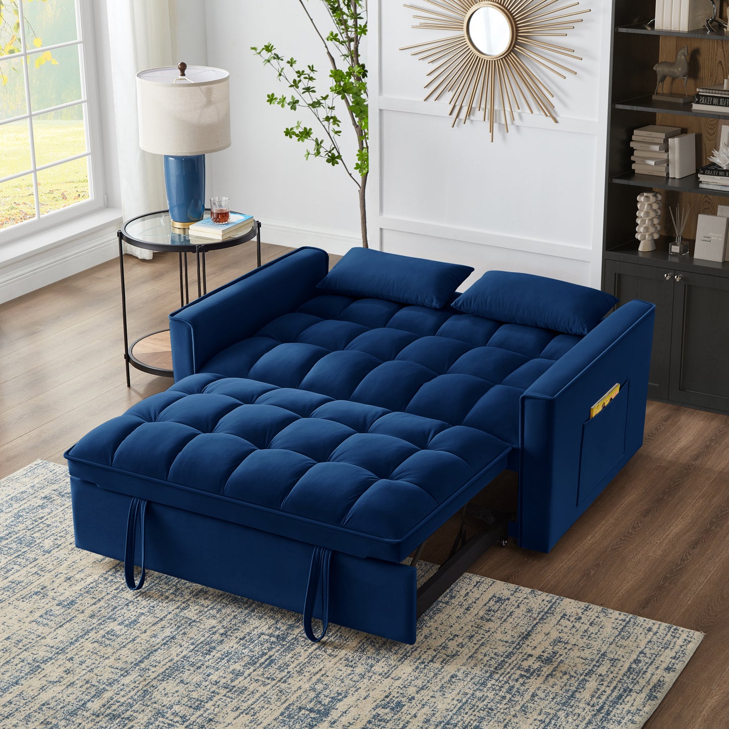 Deep blue velvet sofa bed with tufted cushions and convenient side pockets