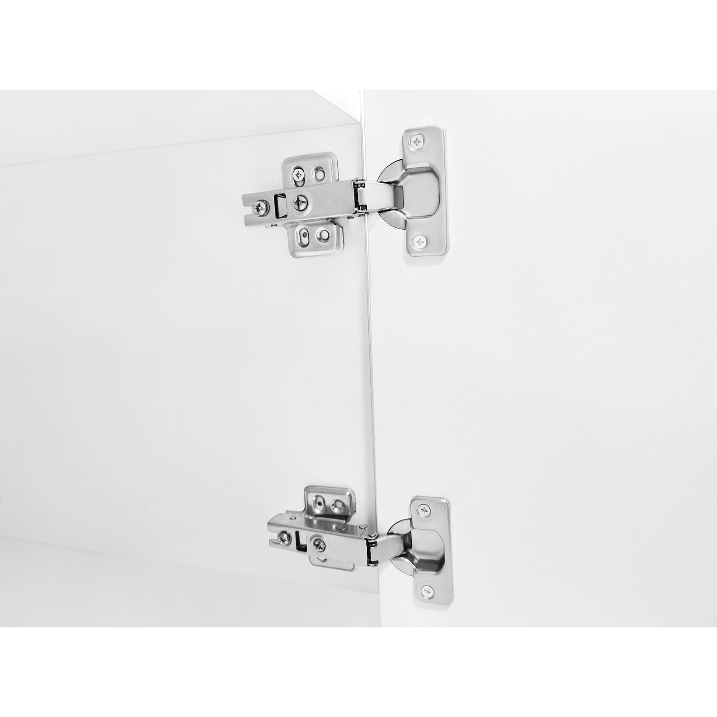 Closeup of two silver cabinet hinges on a white door showing detail and mechanism
