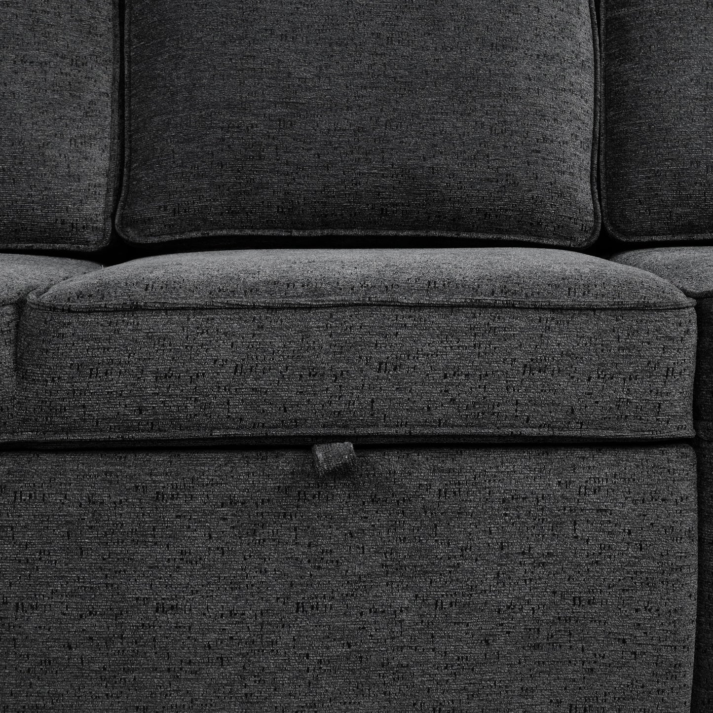 Closeup of dark gray textured fabric sofa cushion with subtle weave pattern