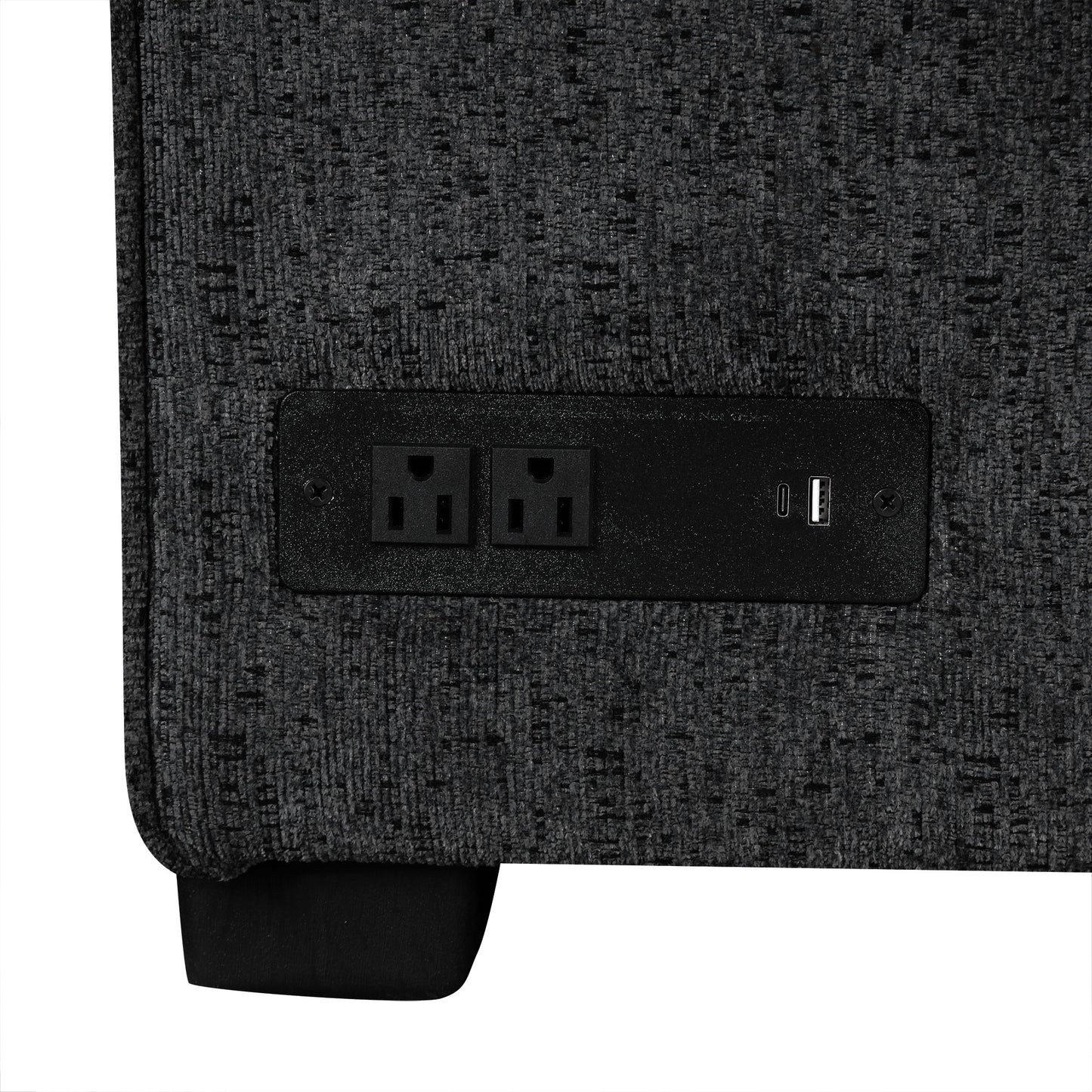Closeup of a charcoal grey fabric armchair with a builtin power outlet and USB port